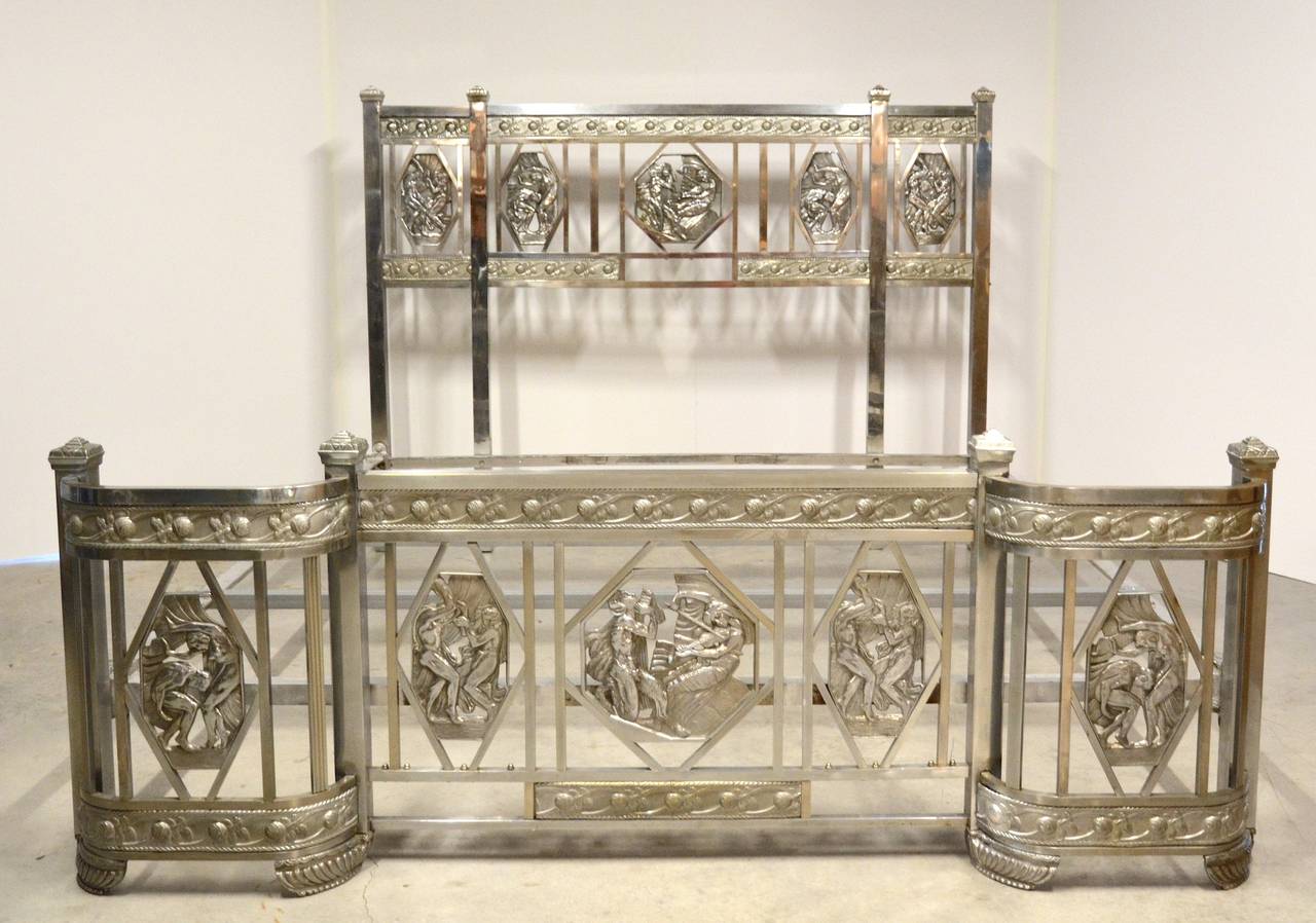 Rare nickel-plated Art Deco bed, headboard and footboard with rails, circa 1930. Gorgeous patina. The head and foot board each having five cast plaques depicting figures dancing and playing musical instruments with Art Nouveau styling.  Fits