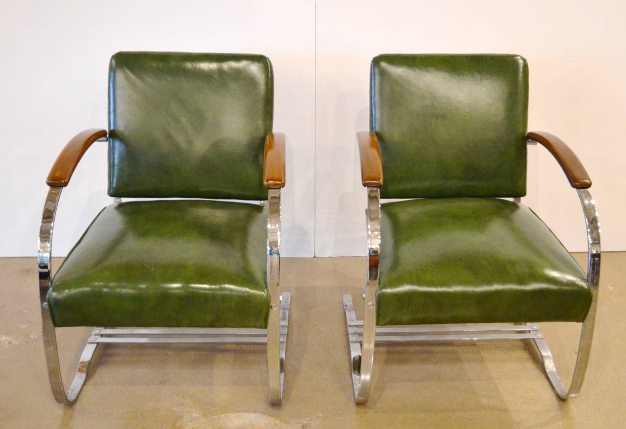 American Art Deco chairs with chrome, original green upholstery and wood arms. Designed by Wolfgang Hoffmann for Howell in 1938. They have a gentle bounce, and thus the name. Sold as pair.