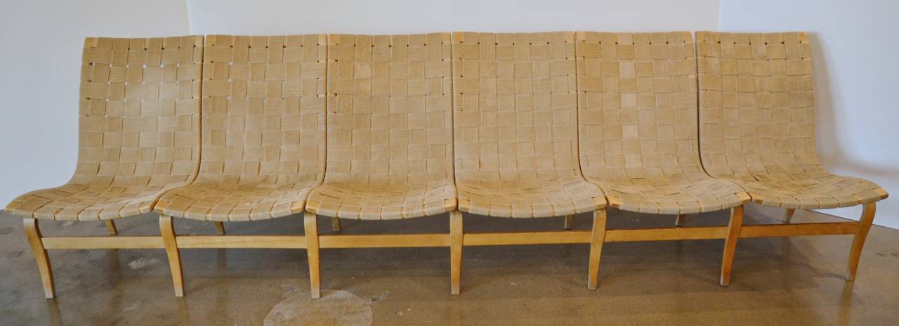 From famed Bauhaus Swedish designer, Bruno Mathsson's, 1930s designed Eva series, comes this very rare 6-seat bench. The iconic seating of bent beechwood and natural hemp webbing allowed it to be assembled into multi-seat configurations. Stamped