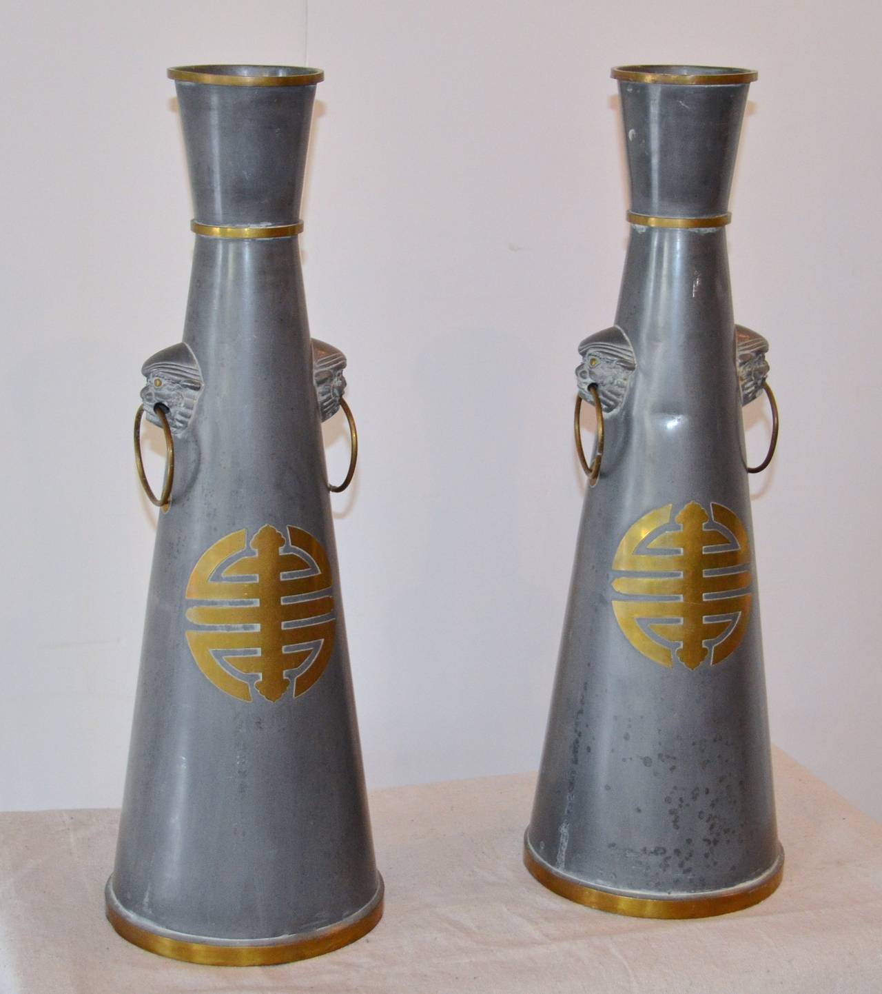 Great scale and materials on these heavy pewter and brass vases bring sophistication to any setting.