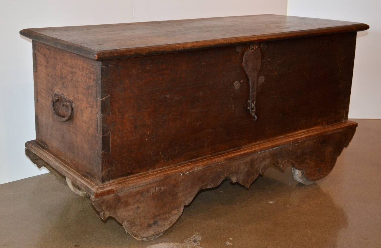 From Central Java, this dark teak chest has mortise and tenon joinery, an undulating skirt, heavy wood wheels and cast iron hardware. Also available, see last photo, is a custom steel and brass console table that layers over the trunk to create a