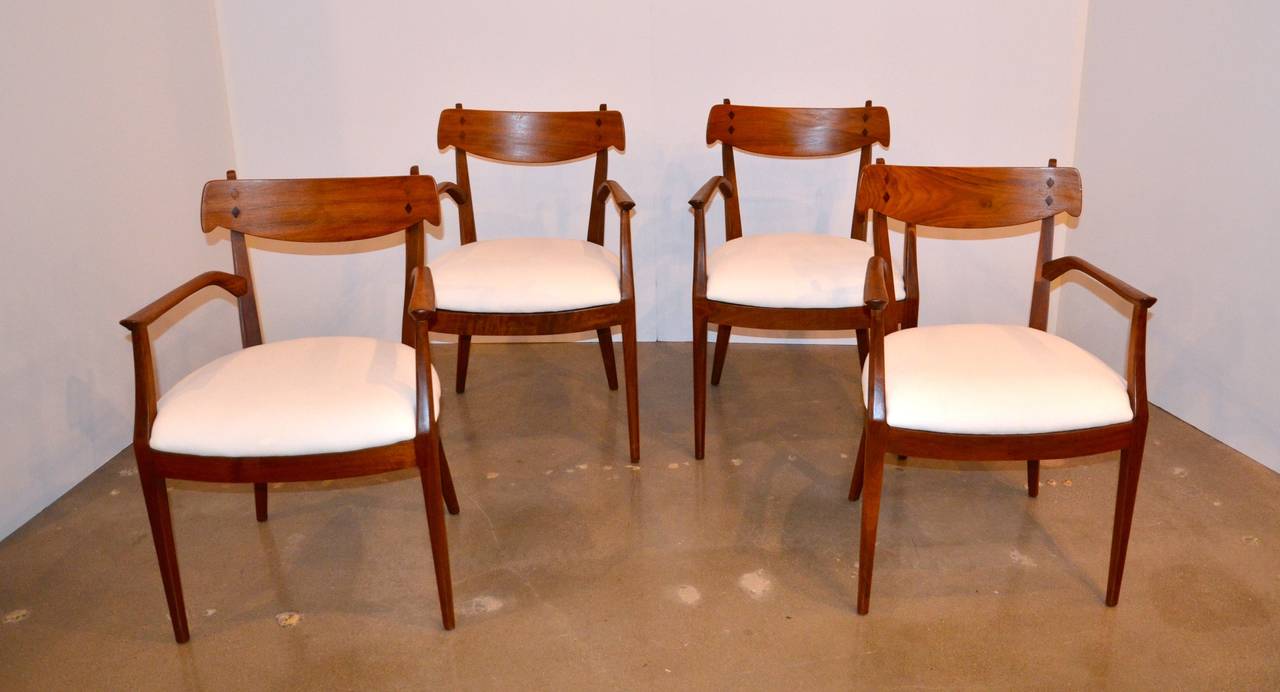 These smartly designed armchairs are of finely carved walnut with rosewood inlays. Designed by Kipp Stewart and Stuart MacDougall for Drexel's Declaration series (circa 1950), they are sturdy, comfortable and seats are upholstered in simple white