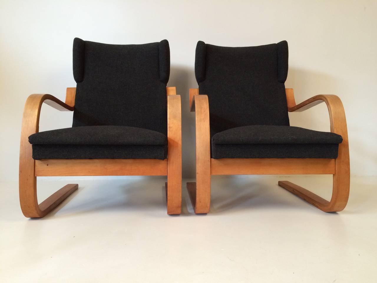Rare pair of 34/402 high back cantilever wing chairs by Alvar Aalto.
Re-upholstered with Kvadrat fabric.
Marked with Aalto Design, made in Finland.