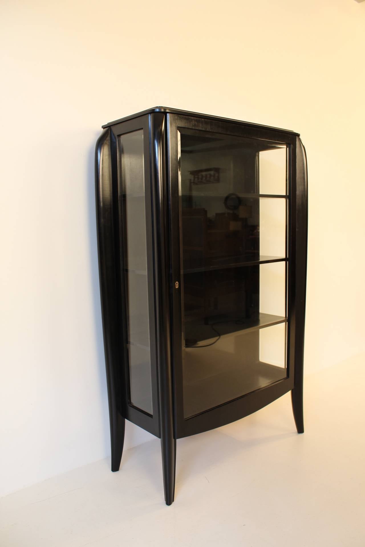 Stunning ebonized French Art Deco display cabinet with beveled glass in door and on both sides.Three original adjustable shelves.
In very good refinished condition.