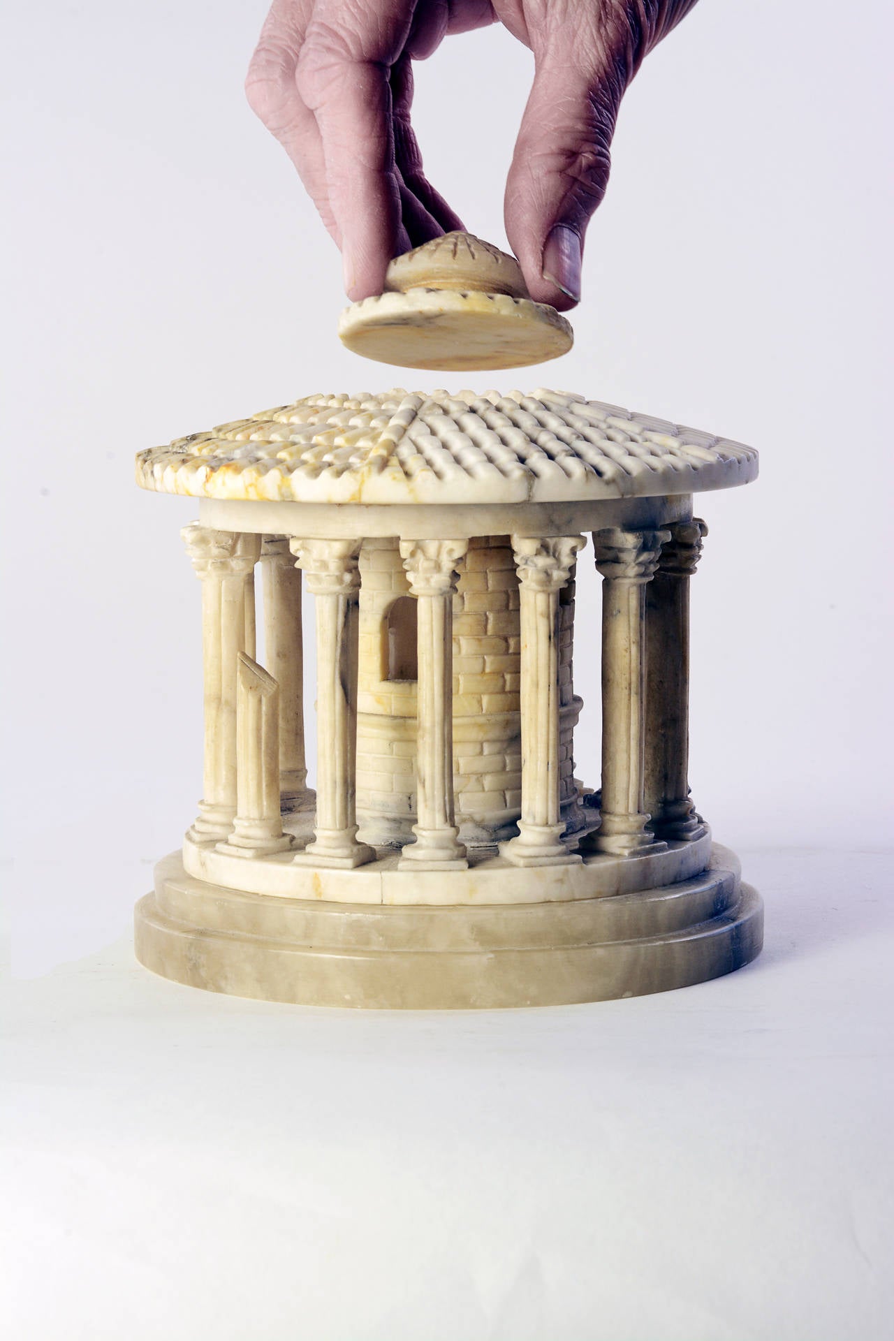 This impressive stone replica of the ancient Roman landmark is unusually detailed. Because all 19th century stone architectural souvenirs are hand carved, artisans were free to make what they wanted. This alabaster model of the Temple of Hercules