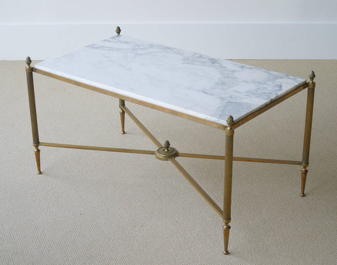 French Maison Jansen classical style coffee table with brass base, marble top, fluted posts with bronze finials, and 