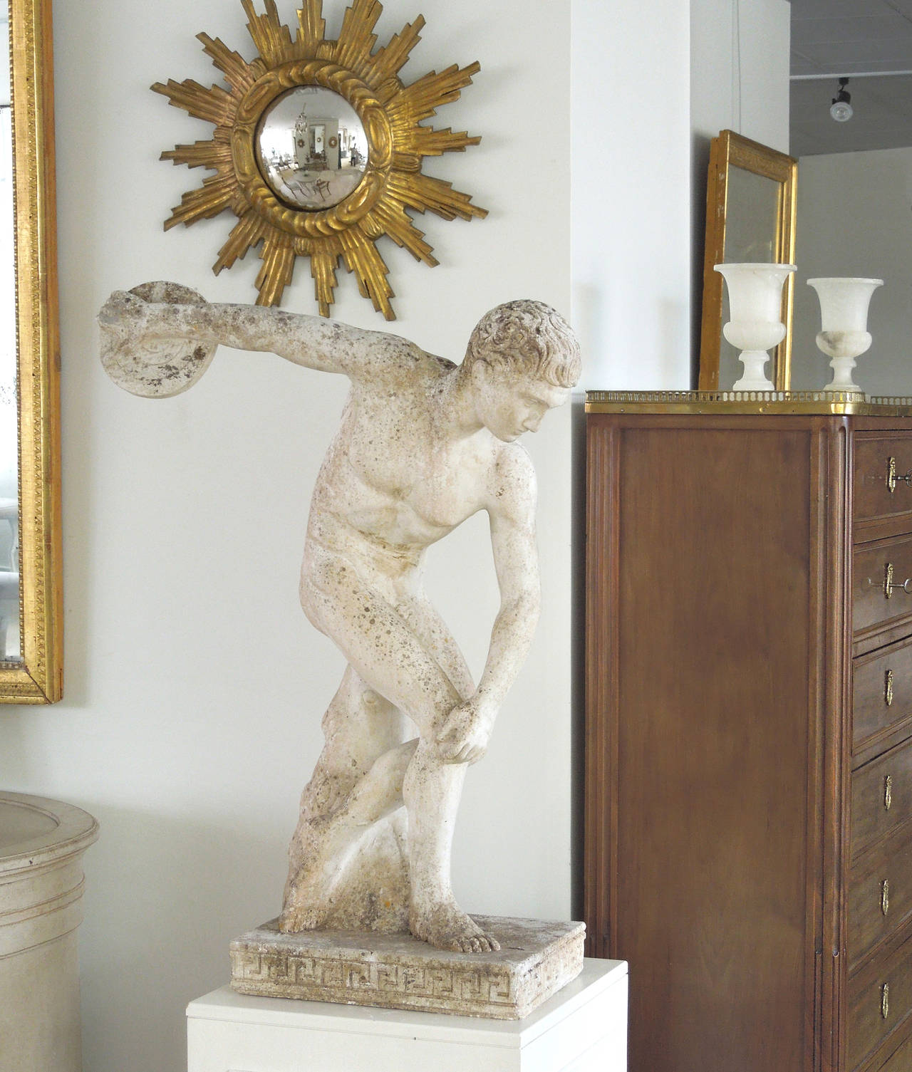 A fine and handsome cast composition garden statue of discus thrower or Discobolus with very unusual and rare Greek key plinth base. This is a copy of the famous copy in the British Museum. The 5th century BC bronze original is attributed to