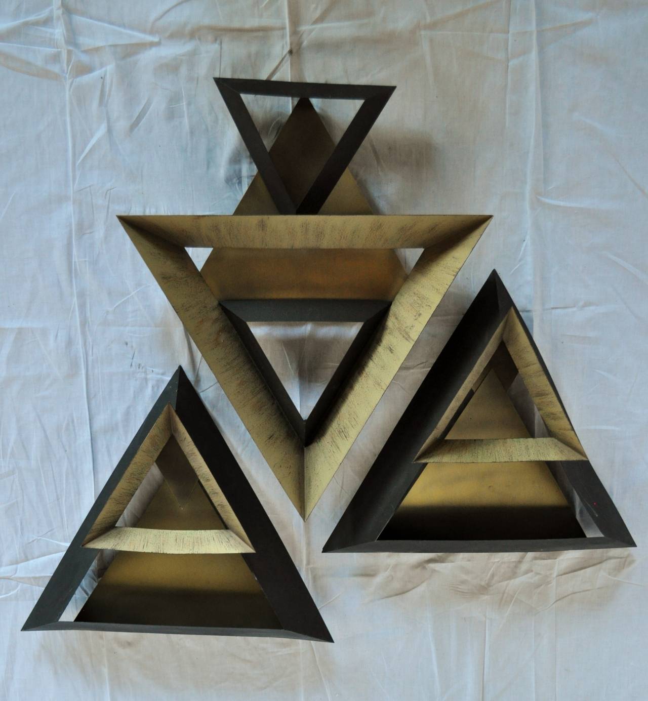 Three-piece triangular wall sculpture set designed by Curtis Jere for Artisan House. Welded and painted mixed metal wall art in original black and gold tones. Welded eye hooks on back of pieces for hanging in multiple configurations.
Signed and