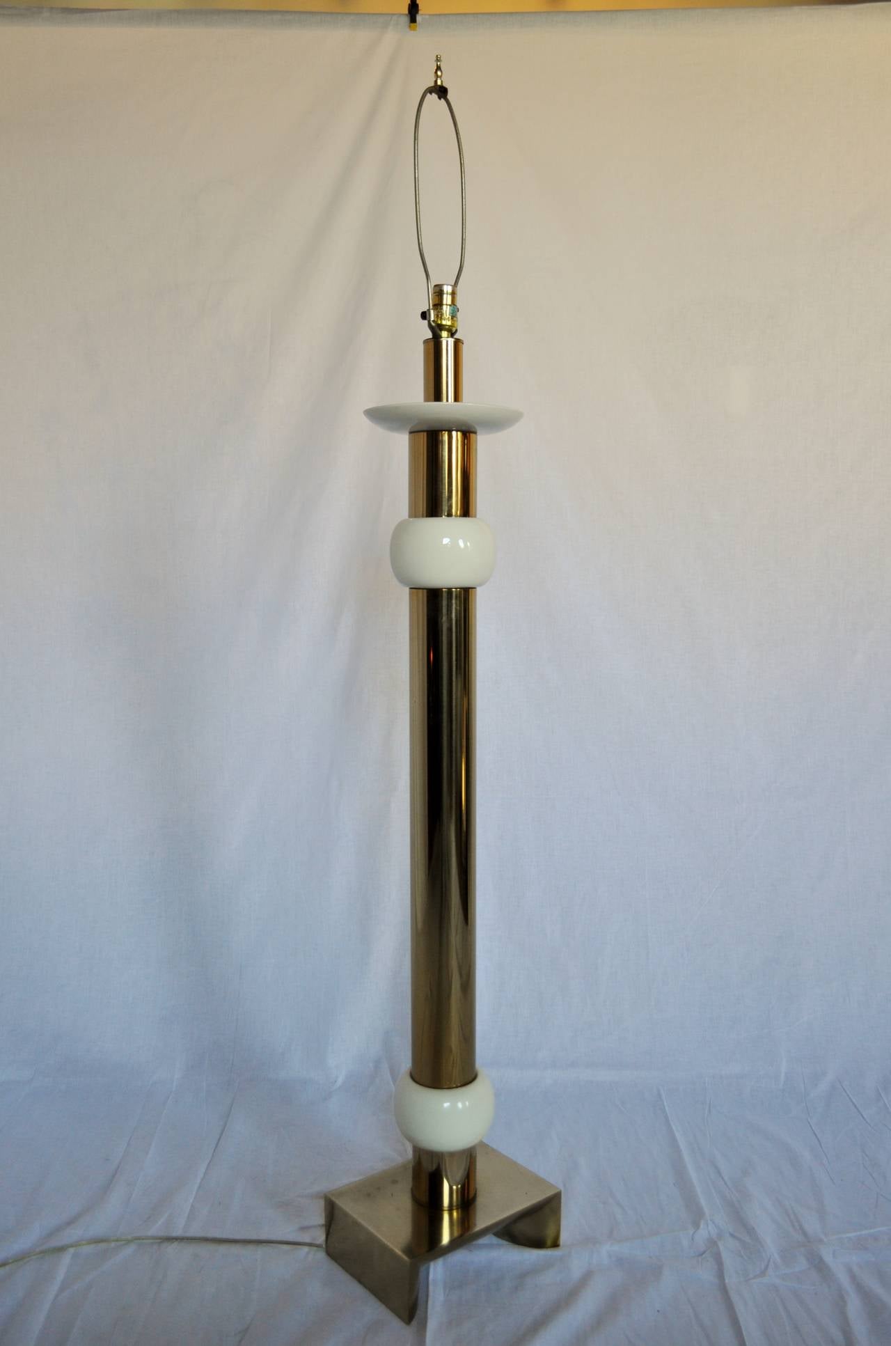 Thick brass column floor lamp by Laurel Lamp Company.  Features cream colored ceramic accents and Asian style pedestal base.  
Original Laurel Lamp sticker on socket.  Wired and in working condition.

Additional Measurements: socket to top of