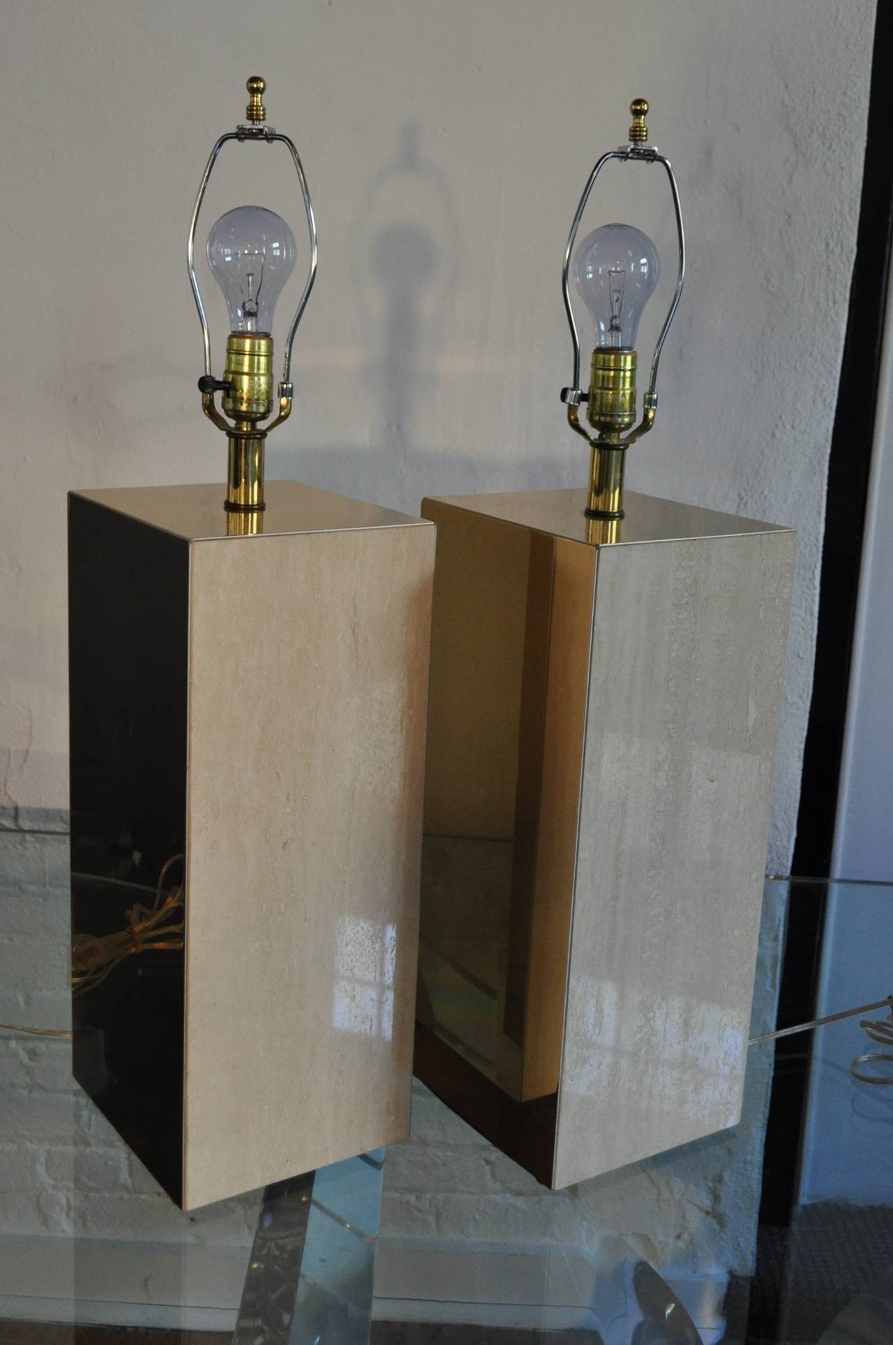 Sculptural Mid Century travertine and brass clad table lamps. 
Wired and in working condition.  Shades not included.