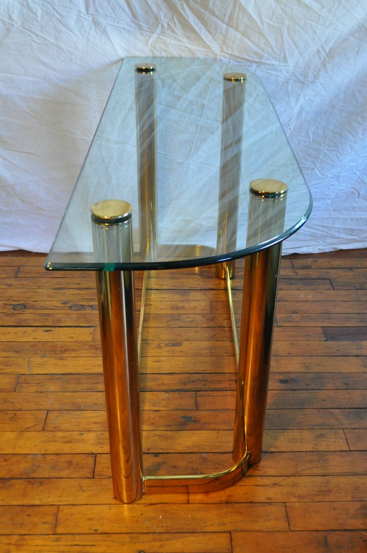 Mid Century modern console table with tubular brass metal frame and beveled glass top.  Can be converted into a two tier glass top table or used with single glass top as shown.  Two glass tops included.  In the style of Pace.  

35.5H With Second