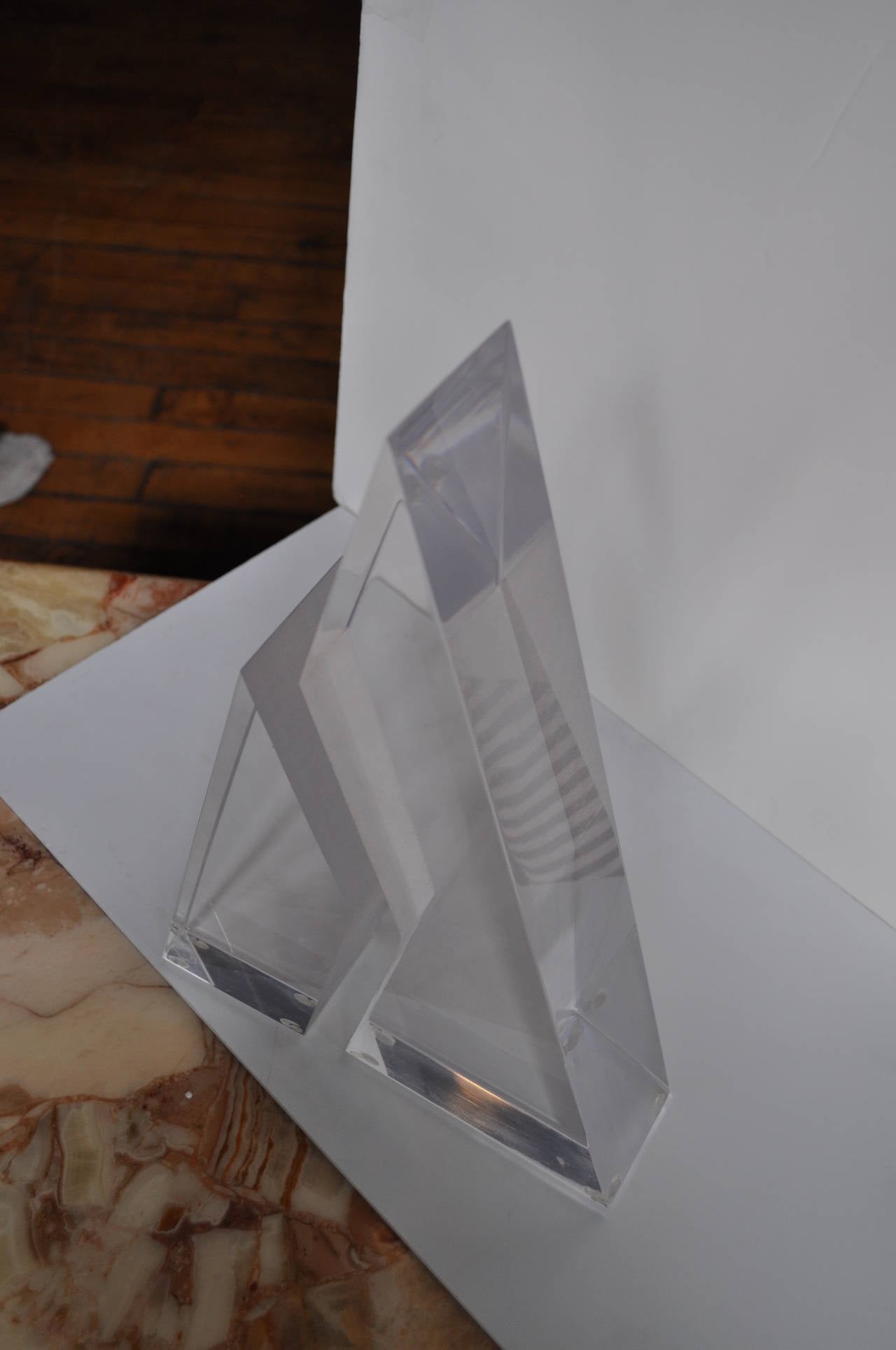 Thick two piece clear Lucite triangular sculpture.