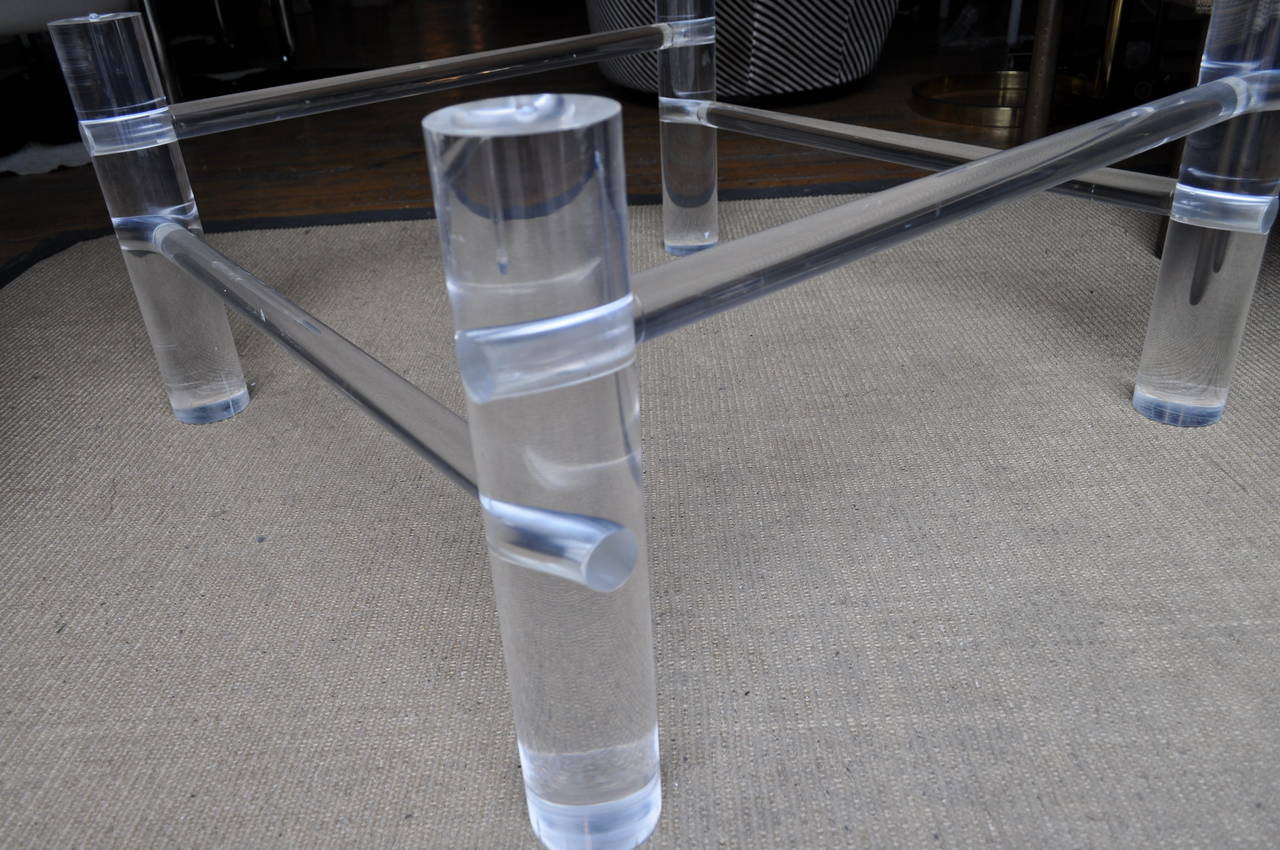Thick weighted tubular square Lucite coffee table base.