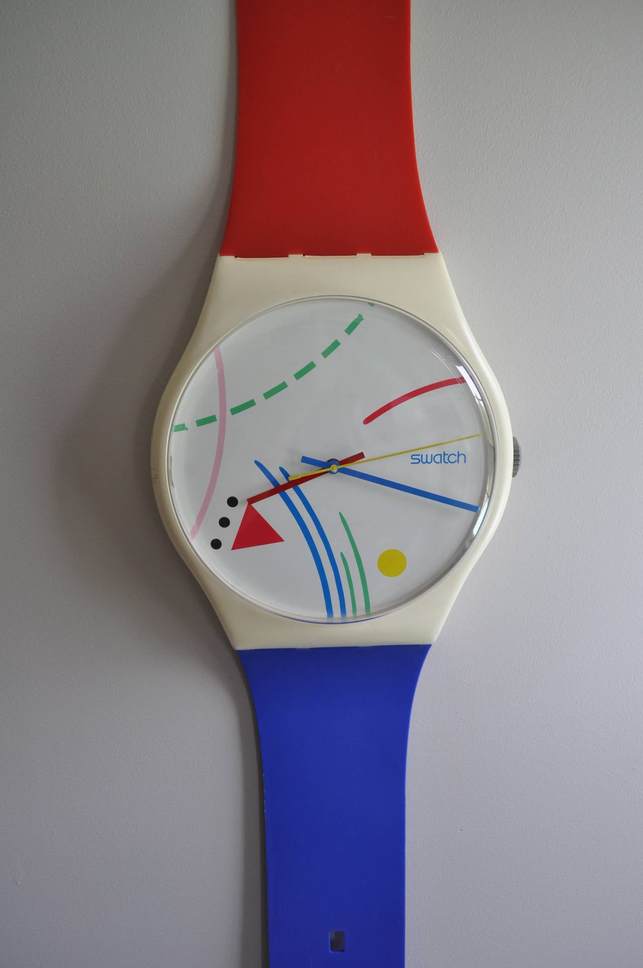 Iconic 1980's Swatch Watch Pop Art Wall Clock.  This wall mounted sculptural piece features bright and bold colors in the style of Vassily Kandinsky style primary red, blue, yellow, black and white colors.  Can be displayed with or without the