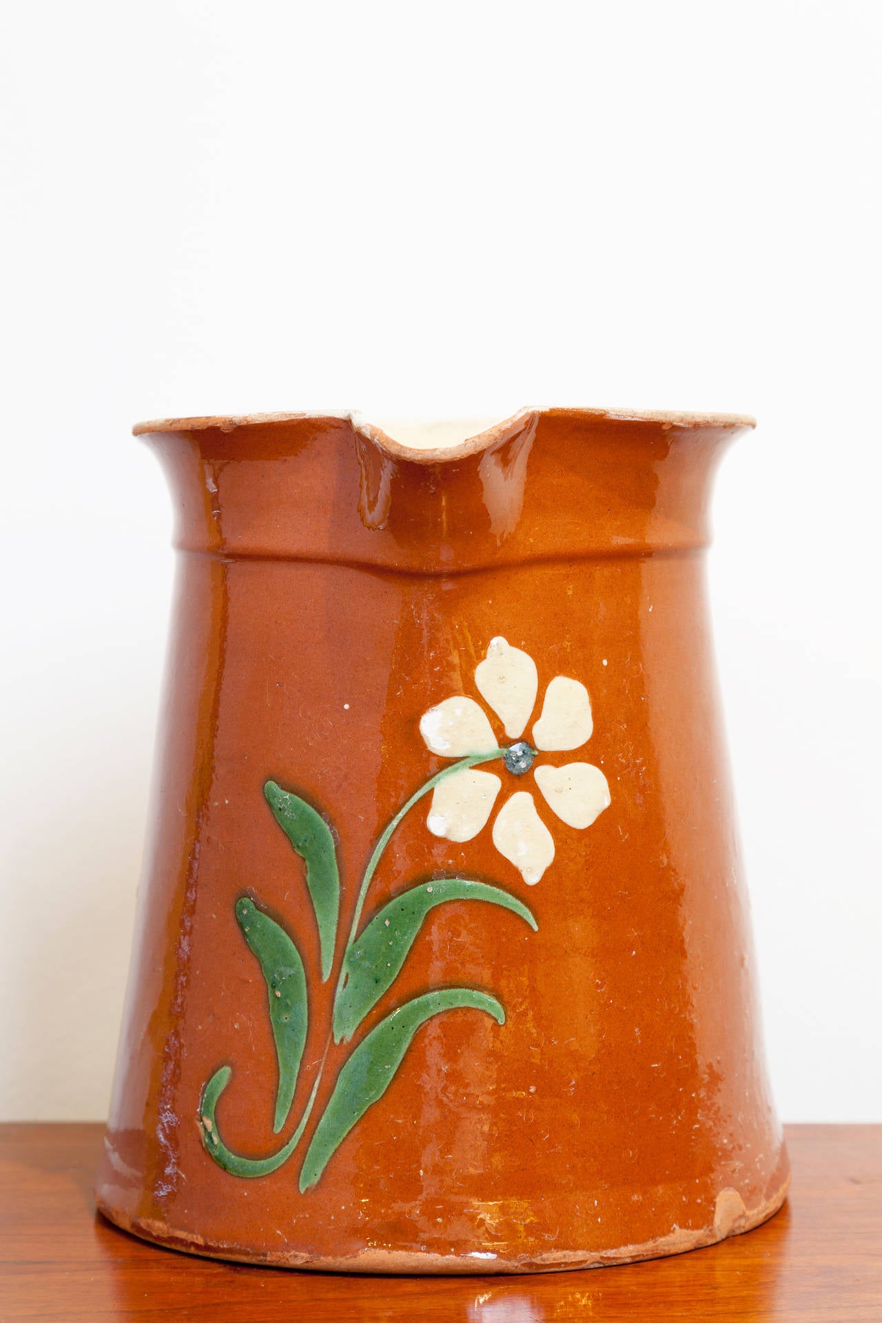 French Savoyard Pitcher, circa 1900. Slipware flower design in green and cream on a terra cotta glaze.