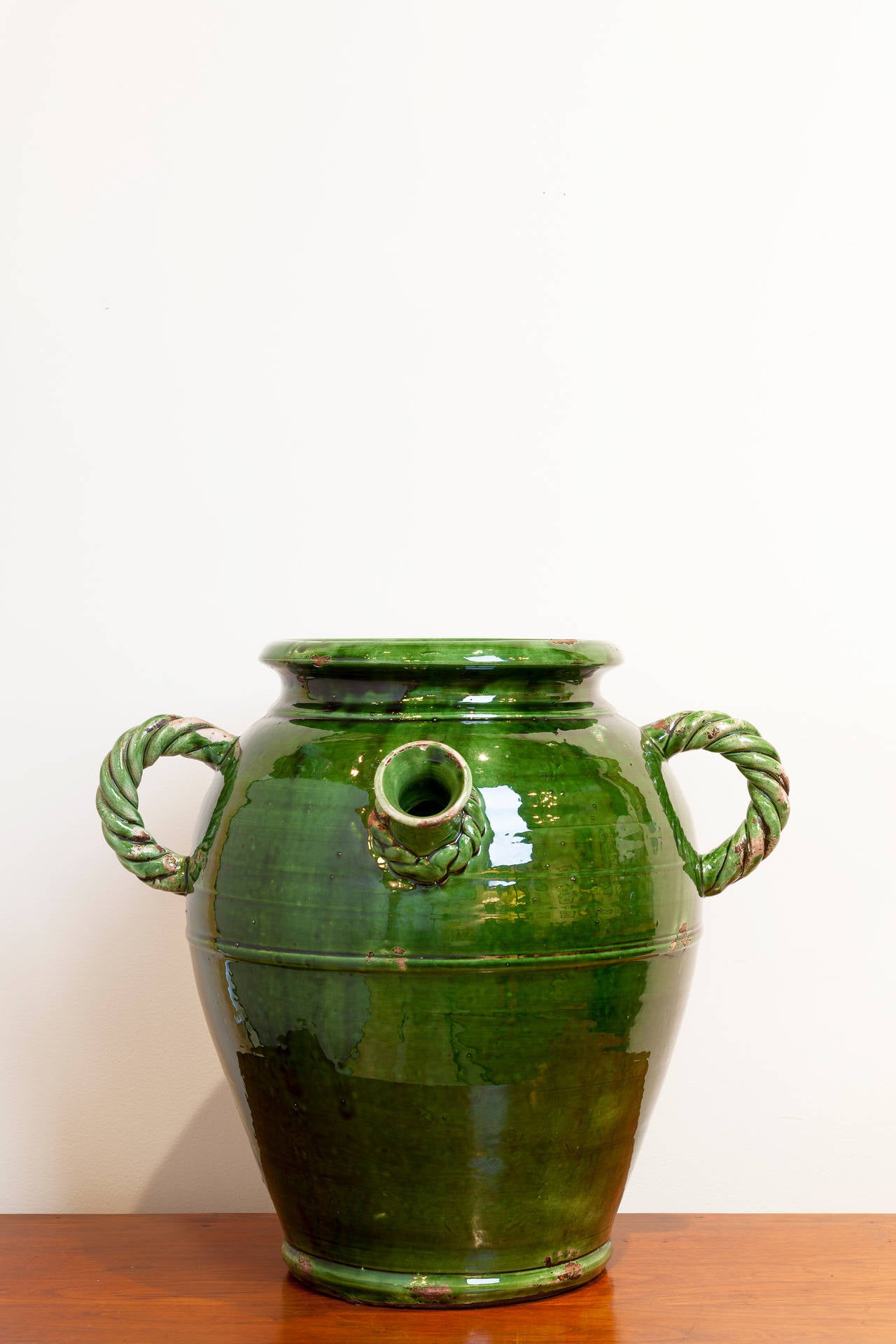 Large French Provençal storage jar, late 19th century. Beautiful deep green glaze with rope-twist handles and detail on spout.