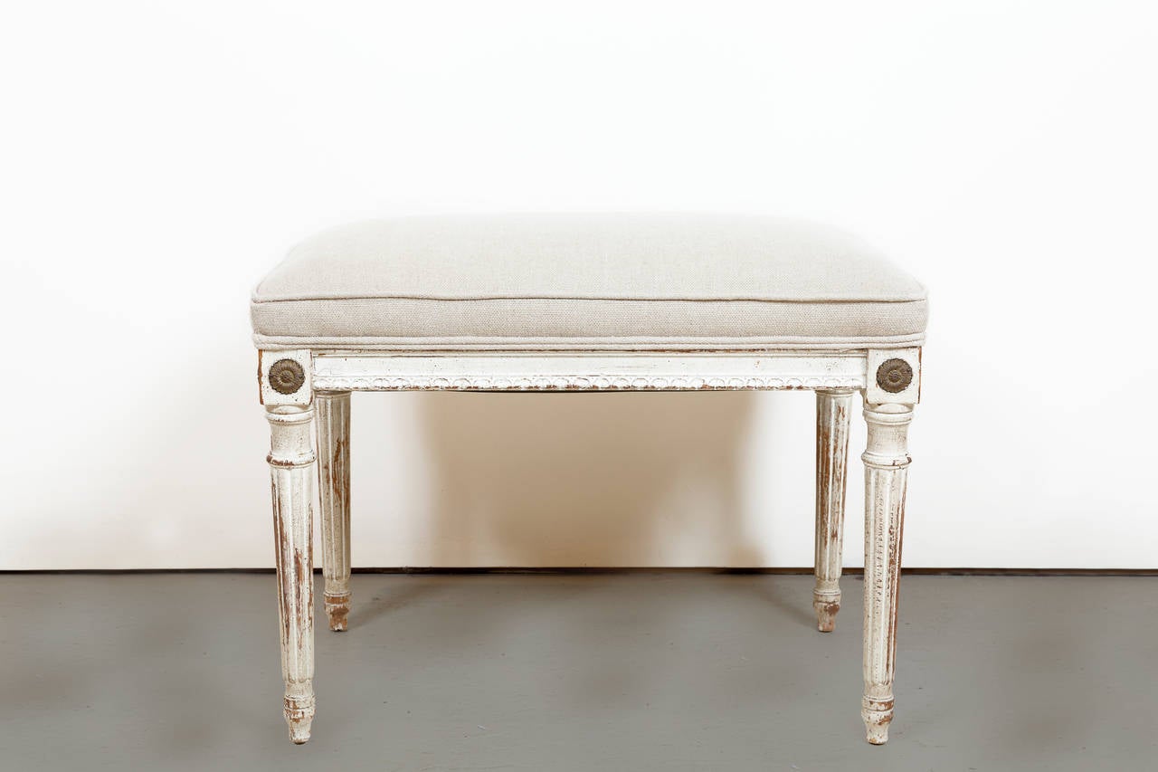 Painted Upholstered Bench with fluted tapered legs. Applied ormolu rosettes. Newly upholstered in Belgian linen. Lovely worn paint.