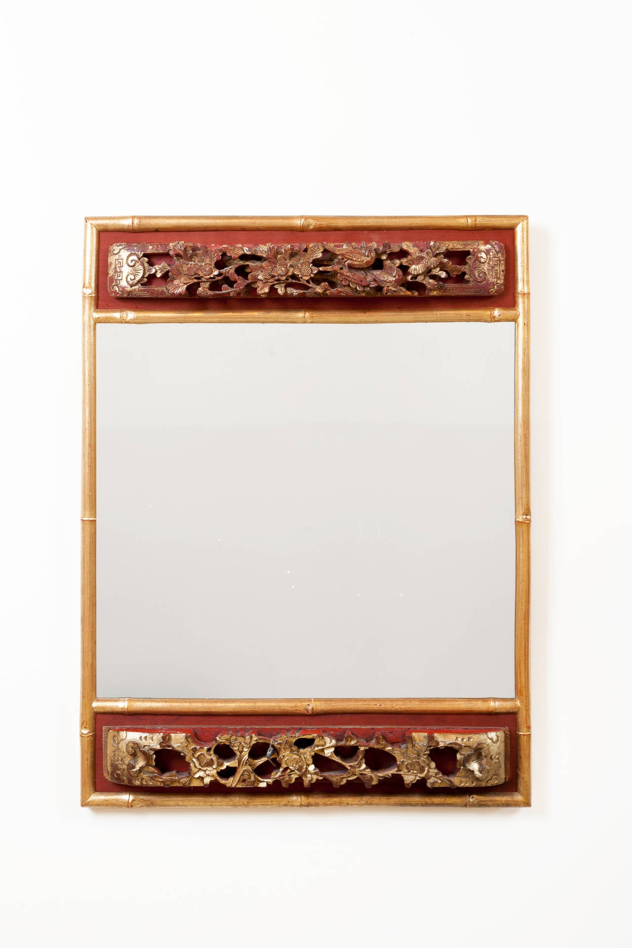 Custom mirror incorporating antique Chinese carvings with bamboo style frame. Chinese carvings have beautiful gilt and lacquer finish. Original lead export tag on one carving.