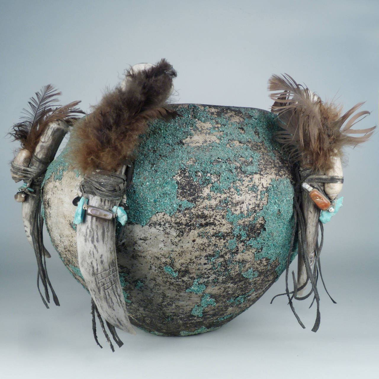 Inspired by the use of personal fetishes by members of many Native American tribes, this pot was designed as a tourist collectible in the early part of the 20th Century. Zuni pots were typically coiled then pit fired. In this instance artist Teddy
