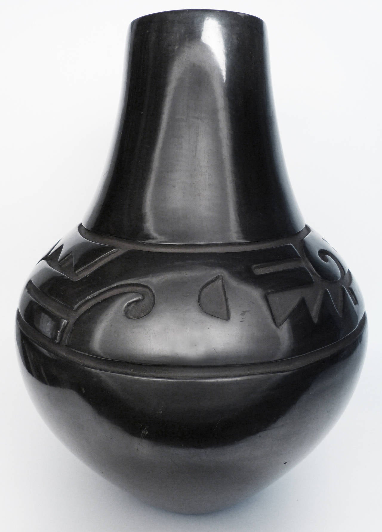 A traditionally made and fired large pot by master Santa Clara Pueblo potter Margaret Tafoya (1905-2001). Carved with traditional designs, and hand-polished with stones to a glossy black, this is a magnificent piece by one of the matriarchs of 20th