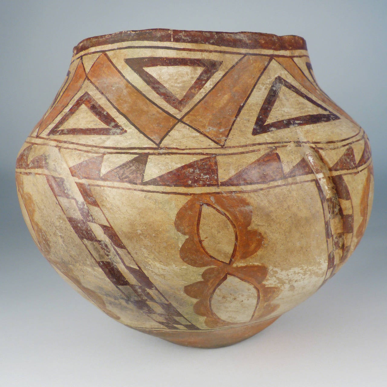 A traditionally made and fired pottery vessel from Laguna Pueblo in New Mexico. This is an exceptional piece with great patina and a highly unusual crimped form that echoes the winter squash grown in the gardens of Pueblo peoples. 9 1/4