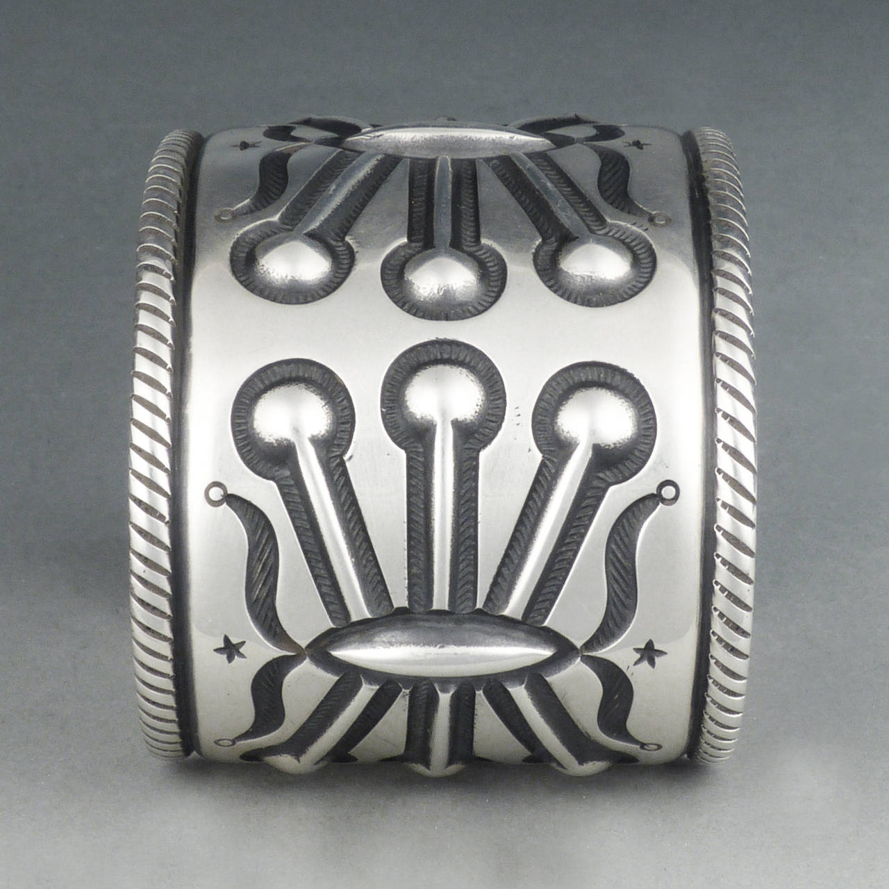 An exquisite piece of jewelry by the one of the most widely sought-after Navajo silversmiths working today.  Exquisitely wrought from heavy gauge sterling silver, the central motif represents a water bug, a sacred creature in Navajo tradition due to