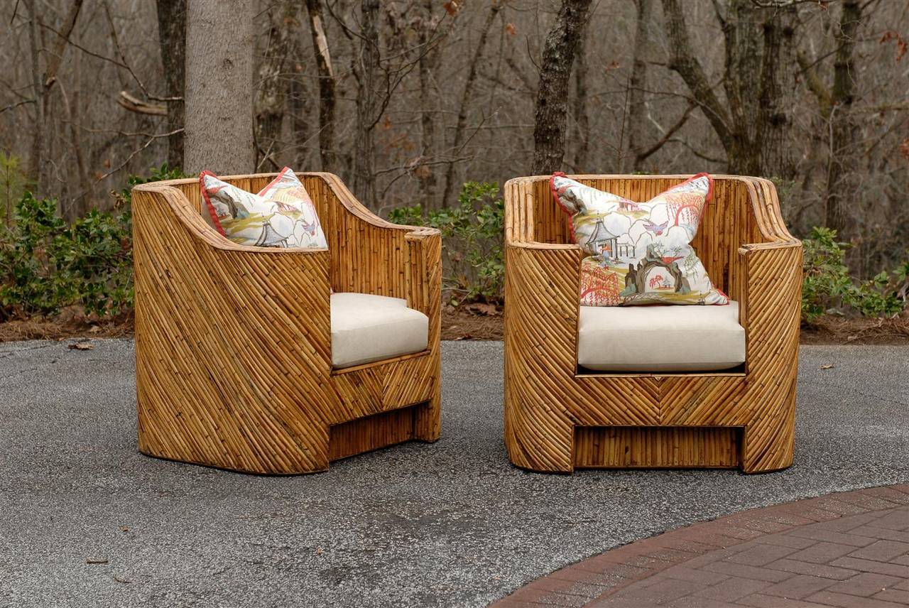 An amazing pair of split bamboo club chairs, circa 1970.  Diagonally applied veneer over hardwood construction. These stout, expertly made pieces are a fabulous way to bring warmth and texture into any interior.  This dramatic pair will do more than