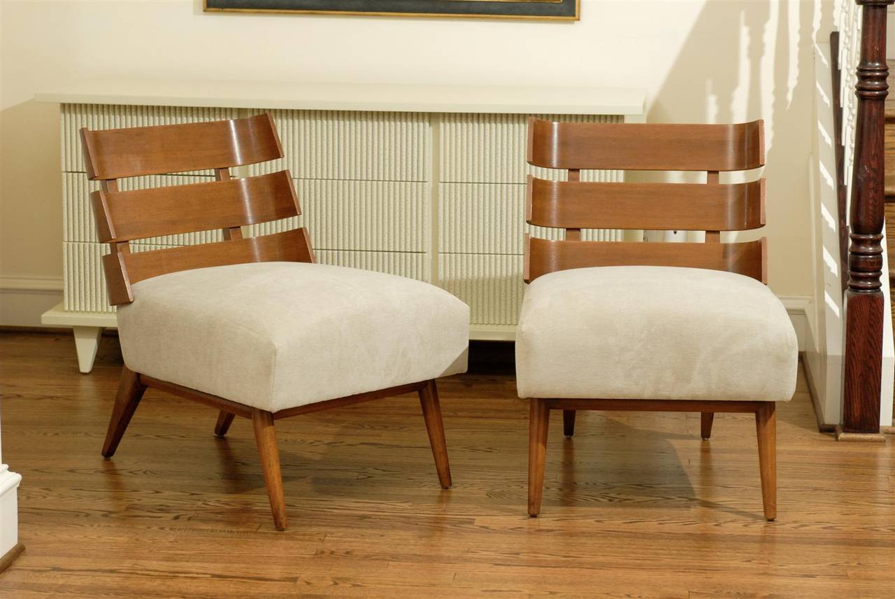 An Outstanding pair of walnut slat back lounge chairs ( model number 1712 ) by T. H. Robsjohn-Gibbings for Widdicomb, circa 1954.  One of the rarest and most coveted designs in the Gibbings catalog.  Extremely comfortable, the chair offers wonderful