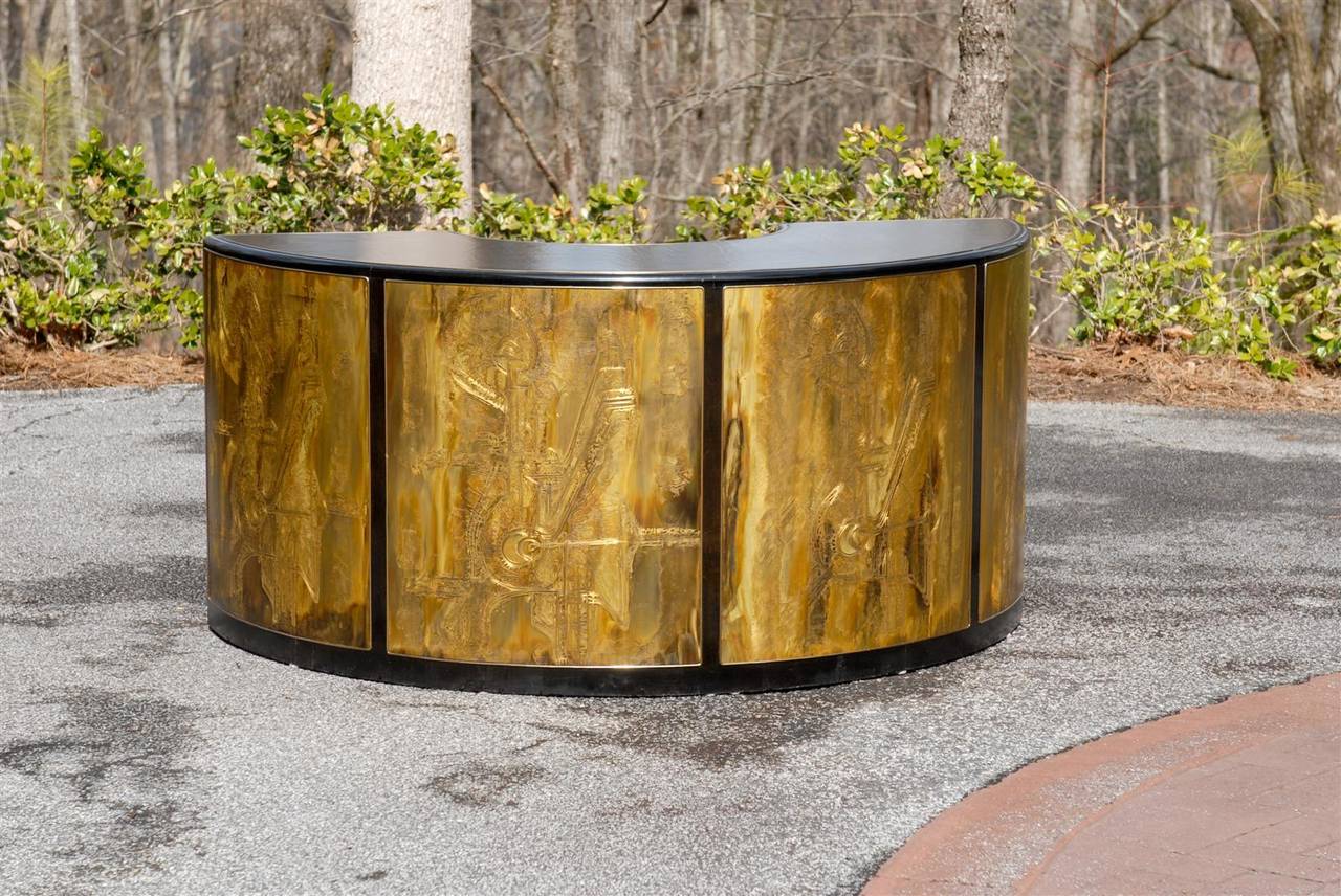 An exceptional curved writing desk or console from the Bernard Rohne for Mastercraft case series, circa 1975. Unique acid-etched brass panels and detailing set against a black lacquer backdrop, with a leather top. Exquisite jewelry! Excellent