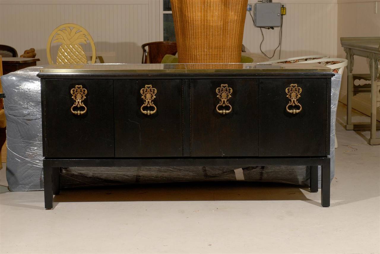 An exquisite buffet or credenza. Mahogany case construction, highlighted by solid brass 