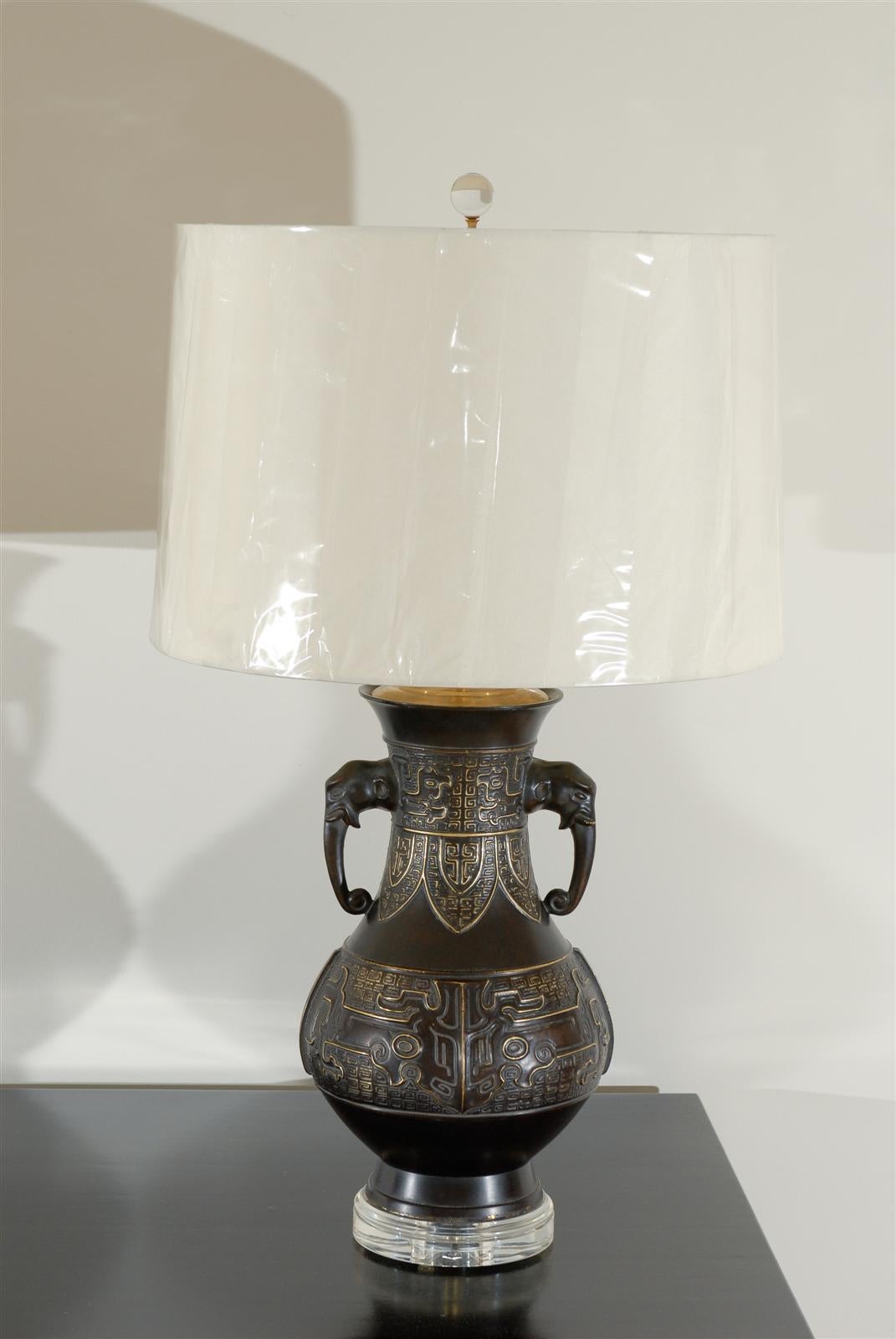 Brass Exceptional Pair of Cast Urn Lamps with Elephant Head Detail For Sale