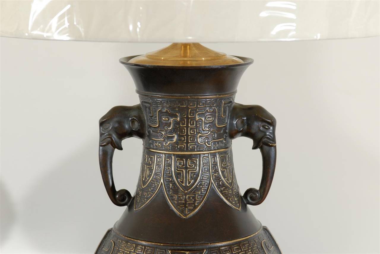 Mid-20th Century Exceptional Pair of Cast Urn Lamps with Elephant Head Detail For Sale