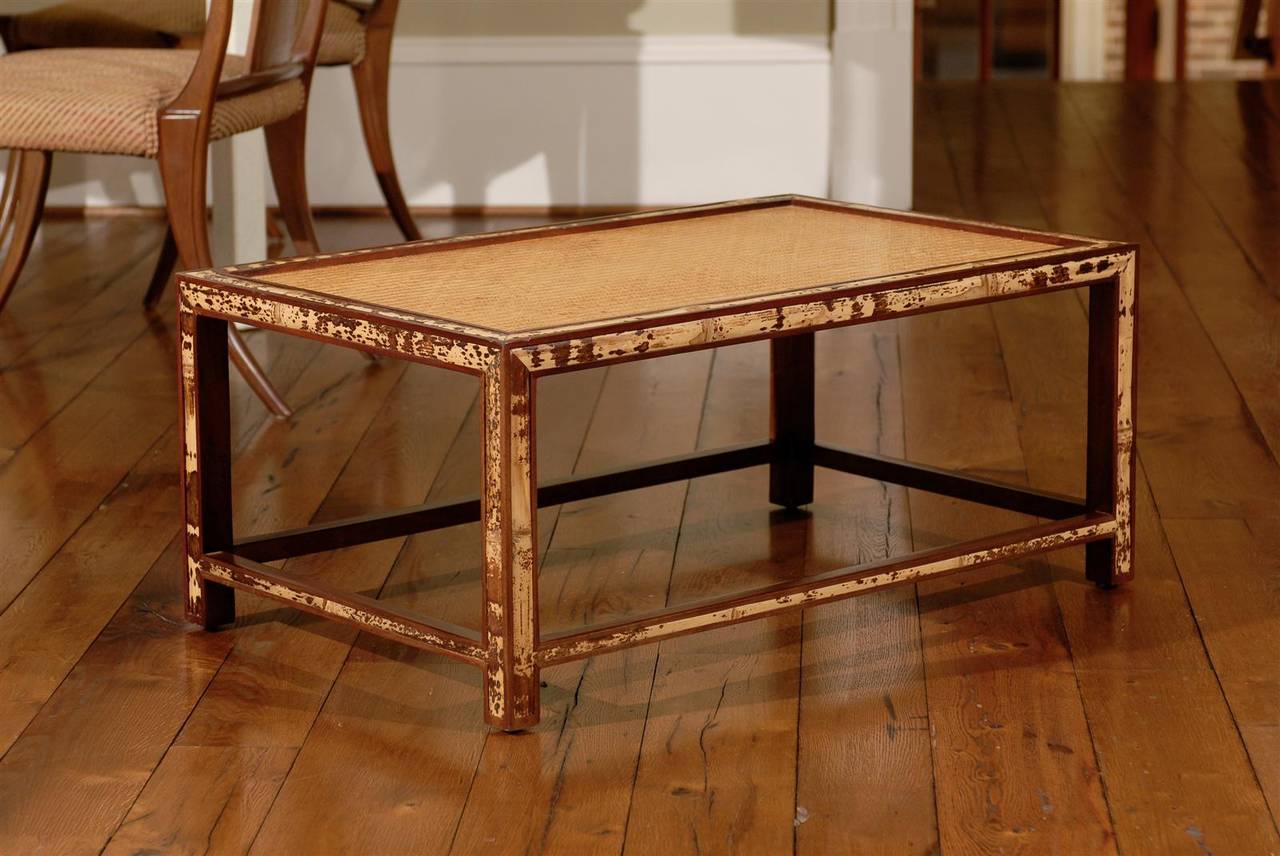 Stunning vintage coffee table, circa 1970s.  Bamboo and mahogany construction with a lovely raffia inset top.  The table displays a fabulous tortoiseshell appearance, with wonderful depth and patina.  A fine, expertly made piece.  Exquisite Jewelry!