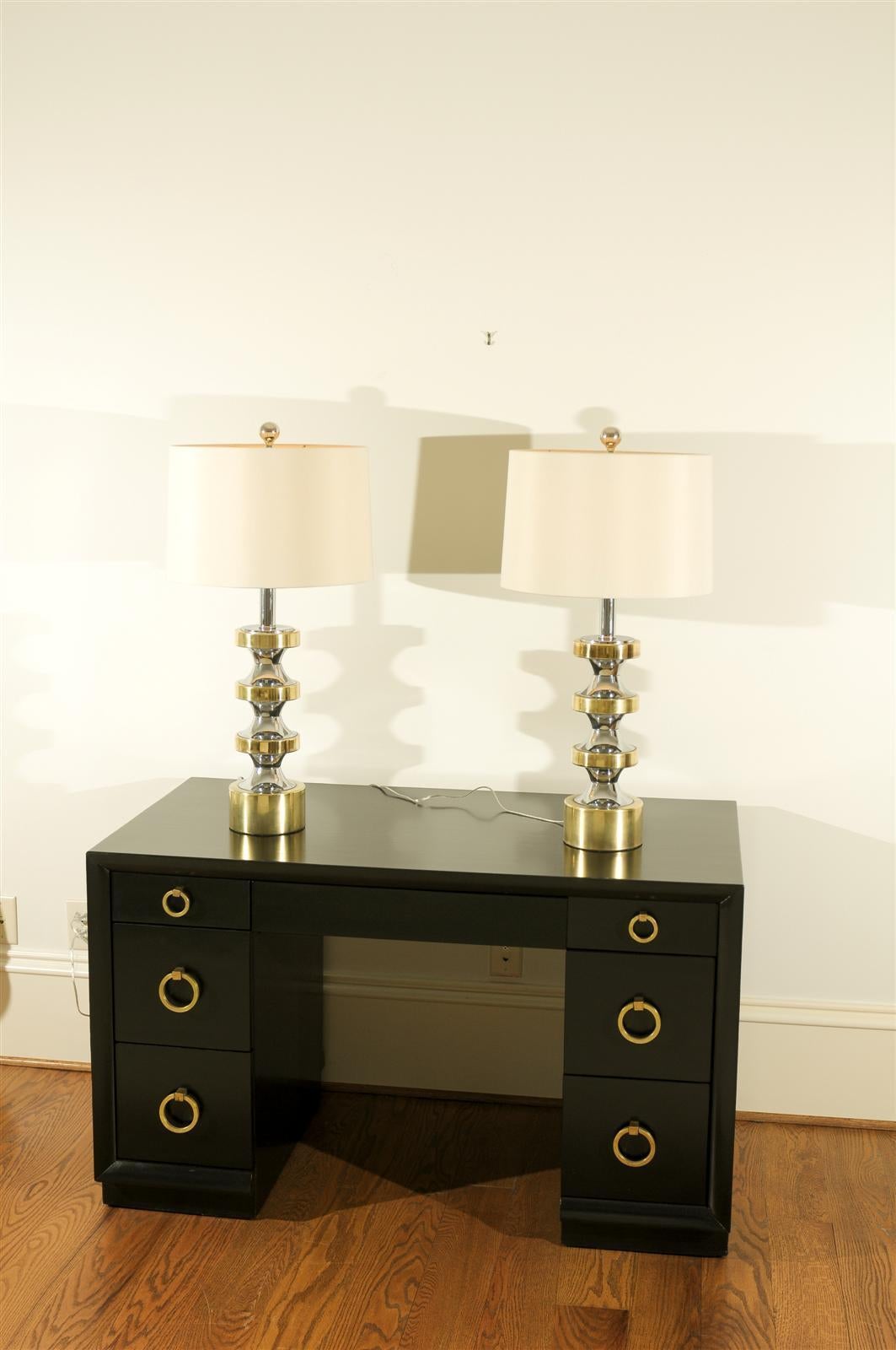 A superb pair of vintage stacked disk lamps in chrome and brass, circa 1970.  The components of these stylish pieces have aged to absolute perfection and display fabulous patina.  Dramatic Jewelry !  Excellent Restored Condition.  The lamps have