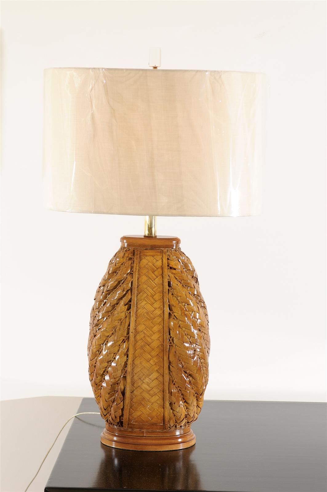 An exceptional pair of vintage rattan lamps, circa 1970.  Beautiful scale and presence.  The pieces have been re-lacquered and display fabulous luster, depth and patina.  Exquisite Jewelry !  Excellent Restored Condition.  Rewired using clear cord