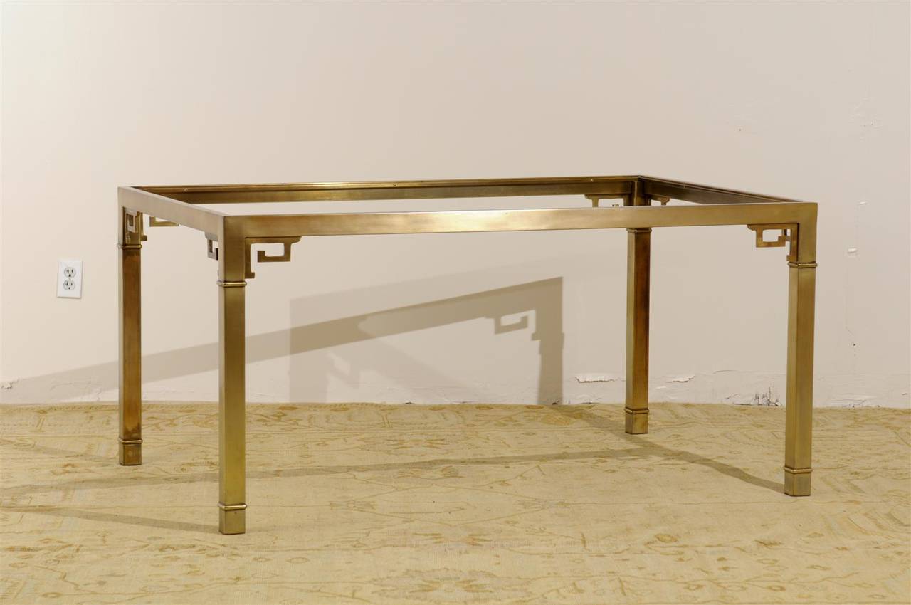 A stunning brass table by Mastercraft, circa 1975.  Brass construction with a fabulous Greek Key detail.  May serve as a dining table or writing desk.  Excellent Vintage Condition, brass with beautiful patina.