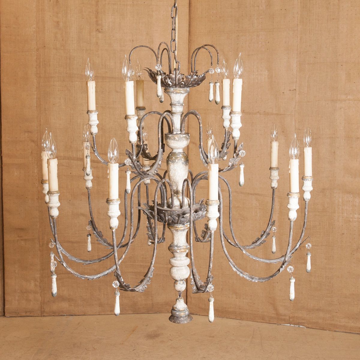 Lighting with a sense of history. Aged patina, carved details and a neutral color. Our Venetian chandelier reflects the Old World charm of Classic European design. Two tiers with 15 curved metal arms that provide plenty of warm light. Handcrafted of