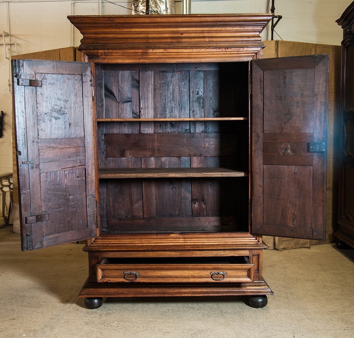 18th century French Louis XIII style chateau armoire. The bold and handsome symmetry of this cabinet was a prized characteristic of furniture created during the reign of Louis XIII (1610-1643) and is fully visible on this piece from a later time.