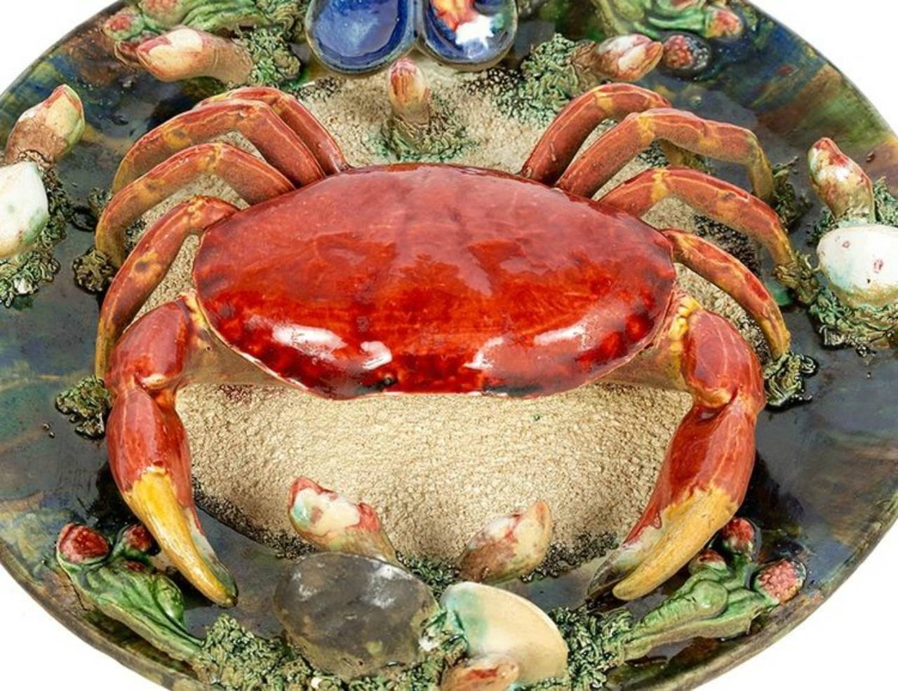 Highly collectible Palissy style trompe-l'oeil crab plate. Portuguese majolica platter features a vibrant red crab on a textured and mottled ground of sand, mussels, seaweed and shells. Impressed marks on the reverse.

We have a set of four