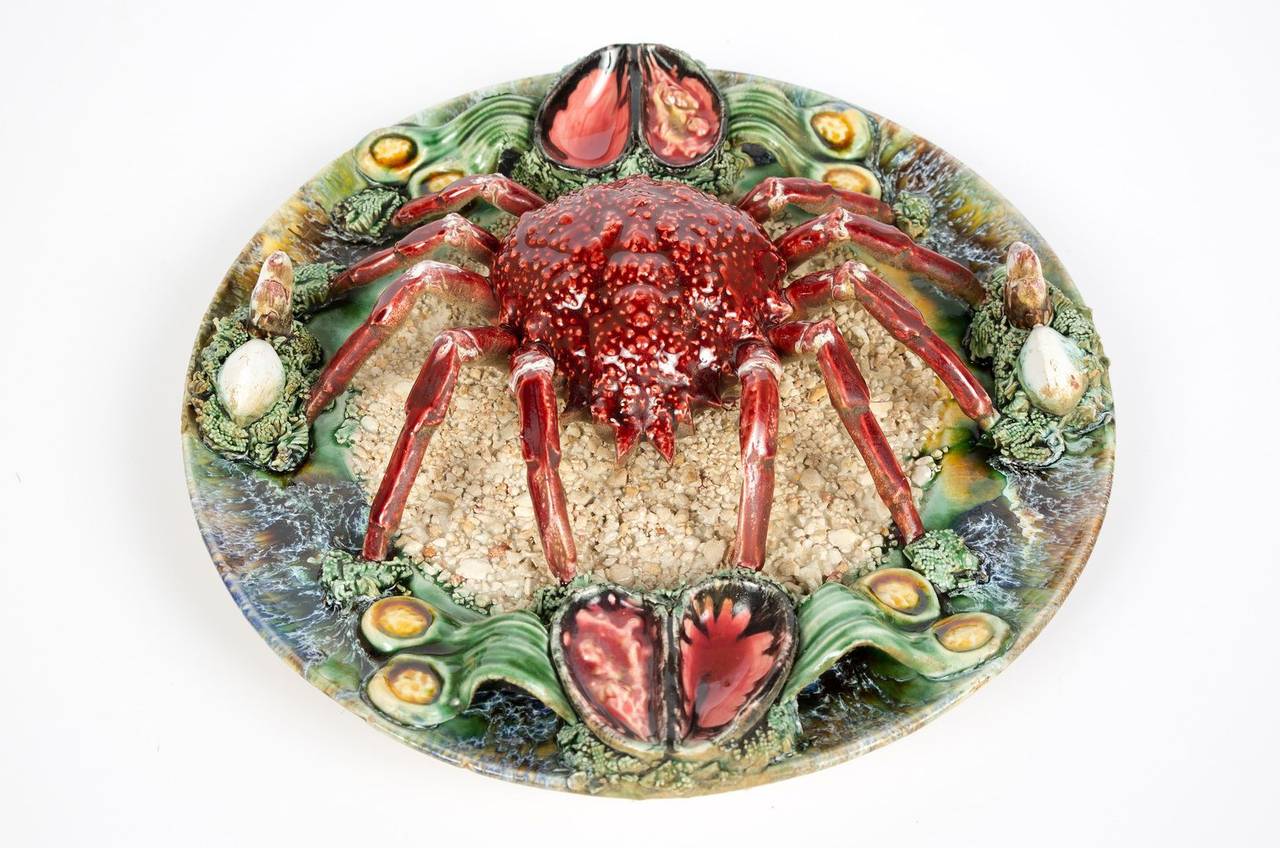 Palissy style majolica spider crab plate. Portuguese trompe-l'oeil platter features a spider crab on a textured and mottled ground of sand, mussels, seaweed and shells. Impressed marks on the reverse. These plates are very collectible.

We have a