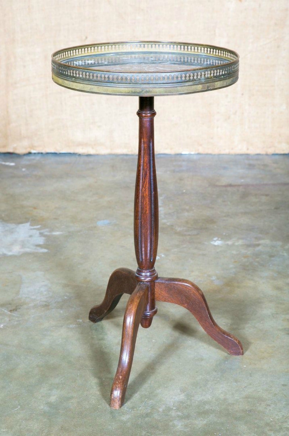 French antique Louis XVI style mahogany gueridon with a grey marble top surrounded by a fretted brass gallery rail, atop a fluted pedestal base with three legs. The perfect perch for a drink or book beside your favorite chair. Paris, France.