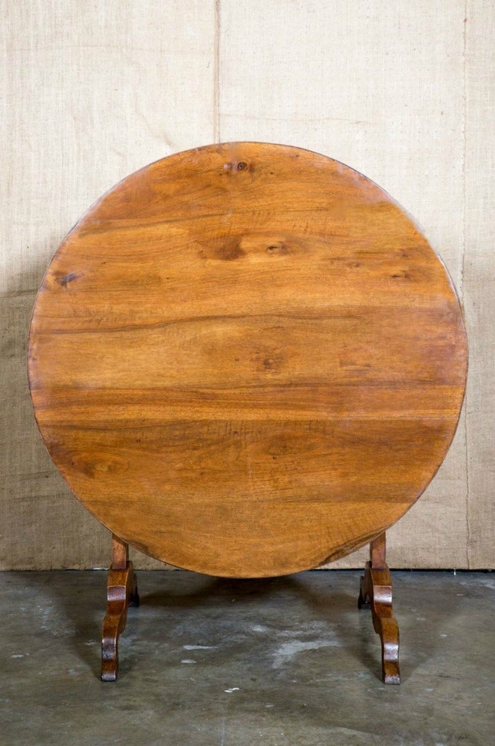 Classic French wine tasting table of solid walnut with a lovely patina. Perfect size to seat four. Traditional base allows the table to tilt and Stand against the wall in the wine cellar when not in use.
