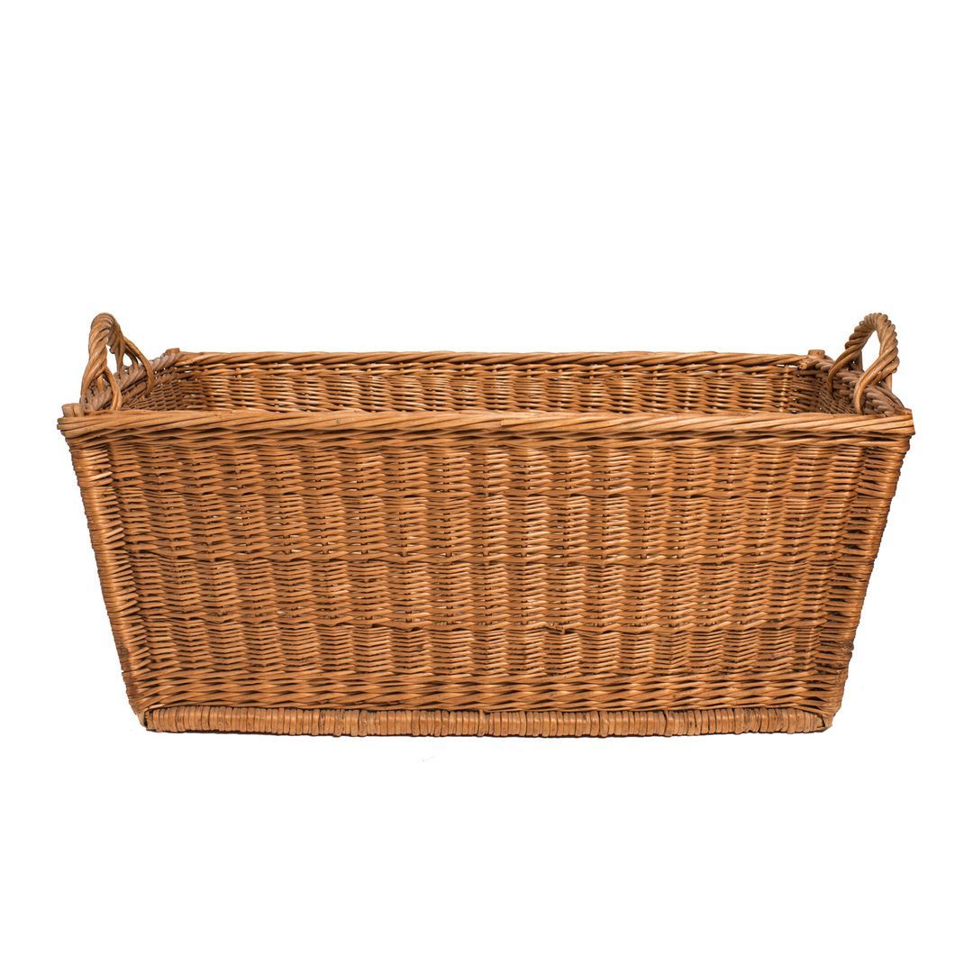 Handwoven natural willow basket with handles and wooden slat bottom runners. All corners have wooden dowels for extra sturdiness. Great storage. So many uses, from laundry to toys to firewood to blankets. Lovely sun bleached patina. Wonderful