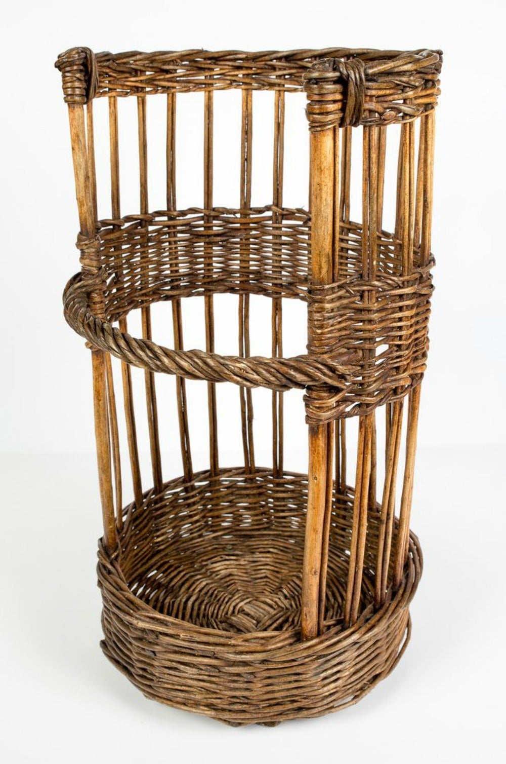 Hard to find open-sided French baguette basket. Circa early 1900s. This semicircle willow basket with a lovely aged patina was used to showcase freshly baked baguettes in a French boulangerie. Wooden slat bottom runners for extra support. A