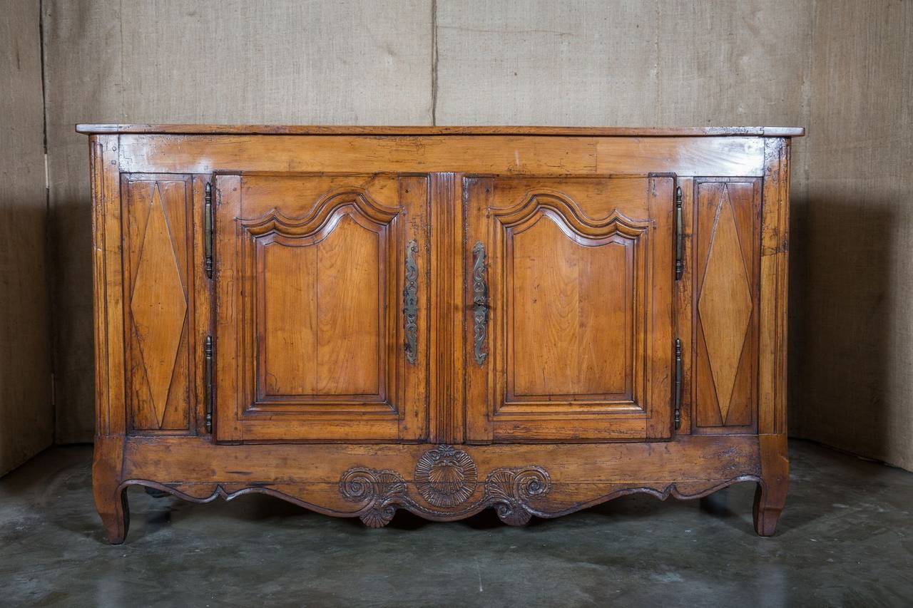 Lovely 18th century cherrywood buffet handcrafted by skilled artisans from the Lyon region during the French Transition period (1750-1775). Most Transition period pieces were created outside Paris by Provincial cabinet makers and combined design
