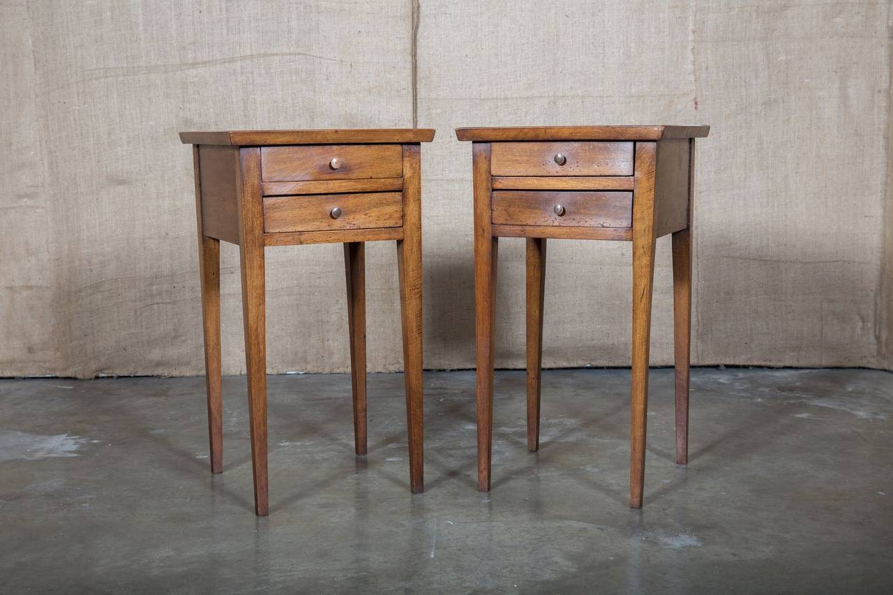 Pair of late 18th century Louis XVI period chevet. Handcrafted from wild cherrywood by rural artisans, these nightstands feature simple detailing with recessed tops over two drawers on tapered legs. They also make great end tables for you favorite