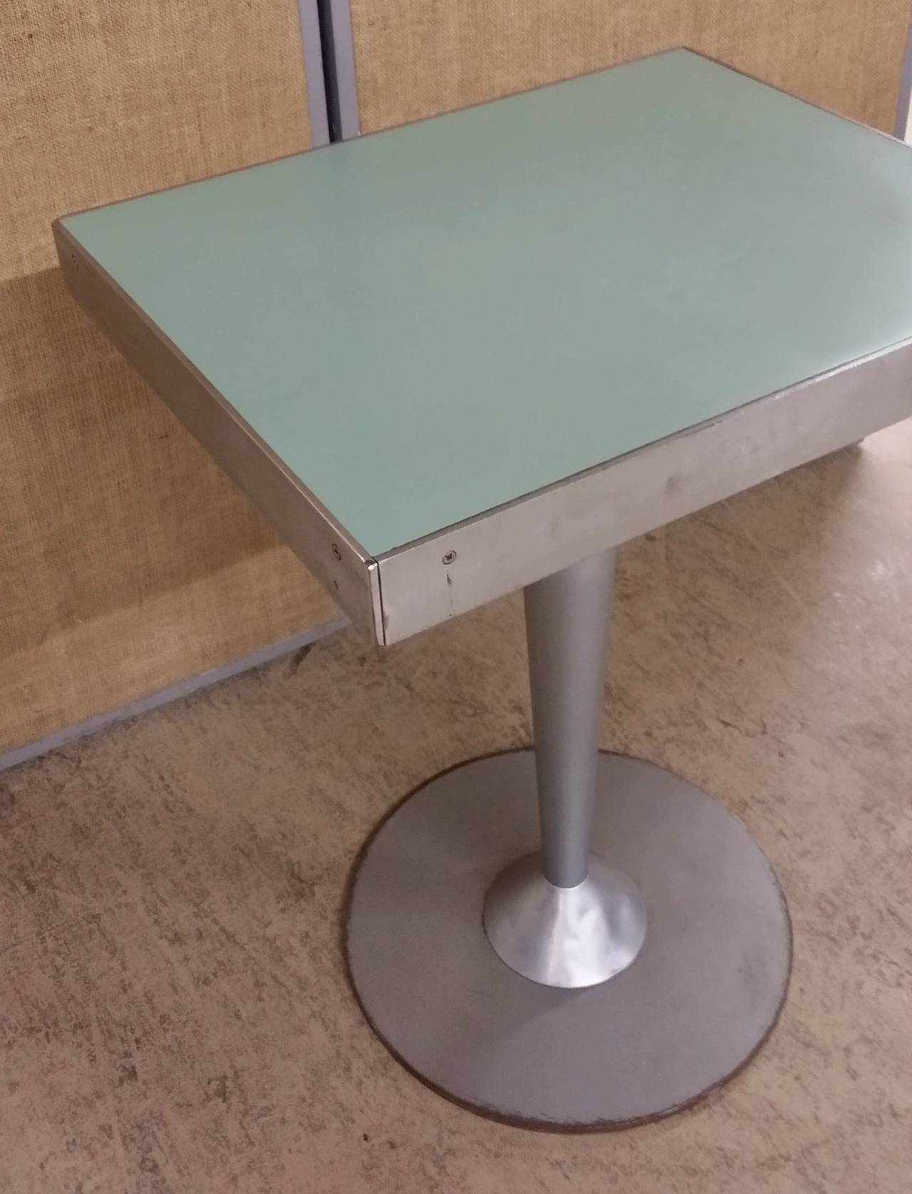 Vintage French bistro/ice cream table with light green formica top on aluminum and steel base. From an ice cream parlor on the Promenade de la Croisette in Cannes. Original condition. We have double pedestal tables also.