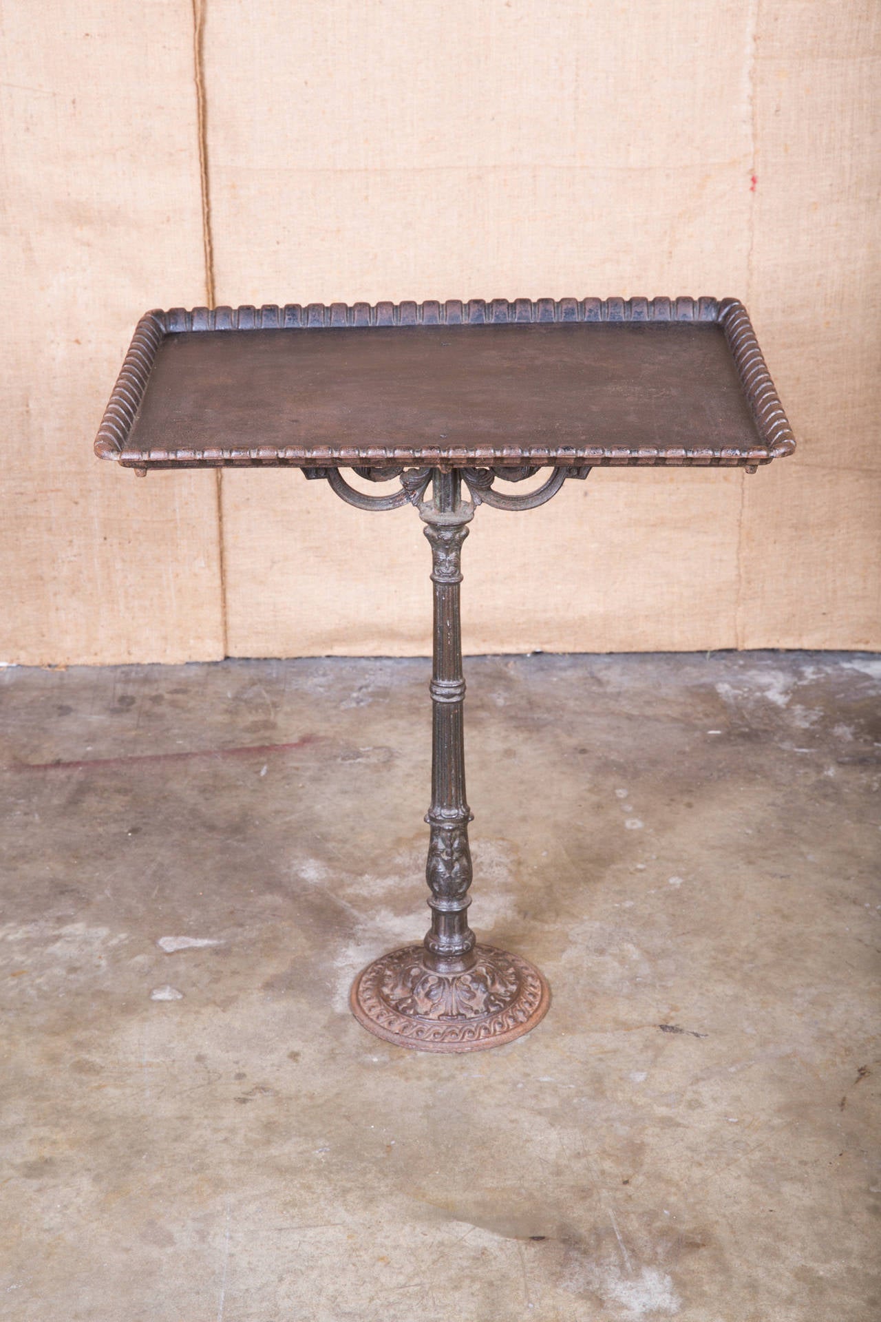 Cast iron dessert table once used at La Flottille Restaurant on the grounds of the Palace of Versailles. This charming table was anchored to the terrace and used to present delicious French desserts in the early 1900s. Original patina. Perfect for