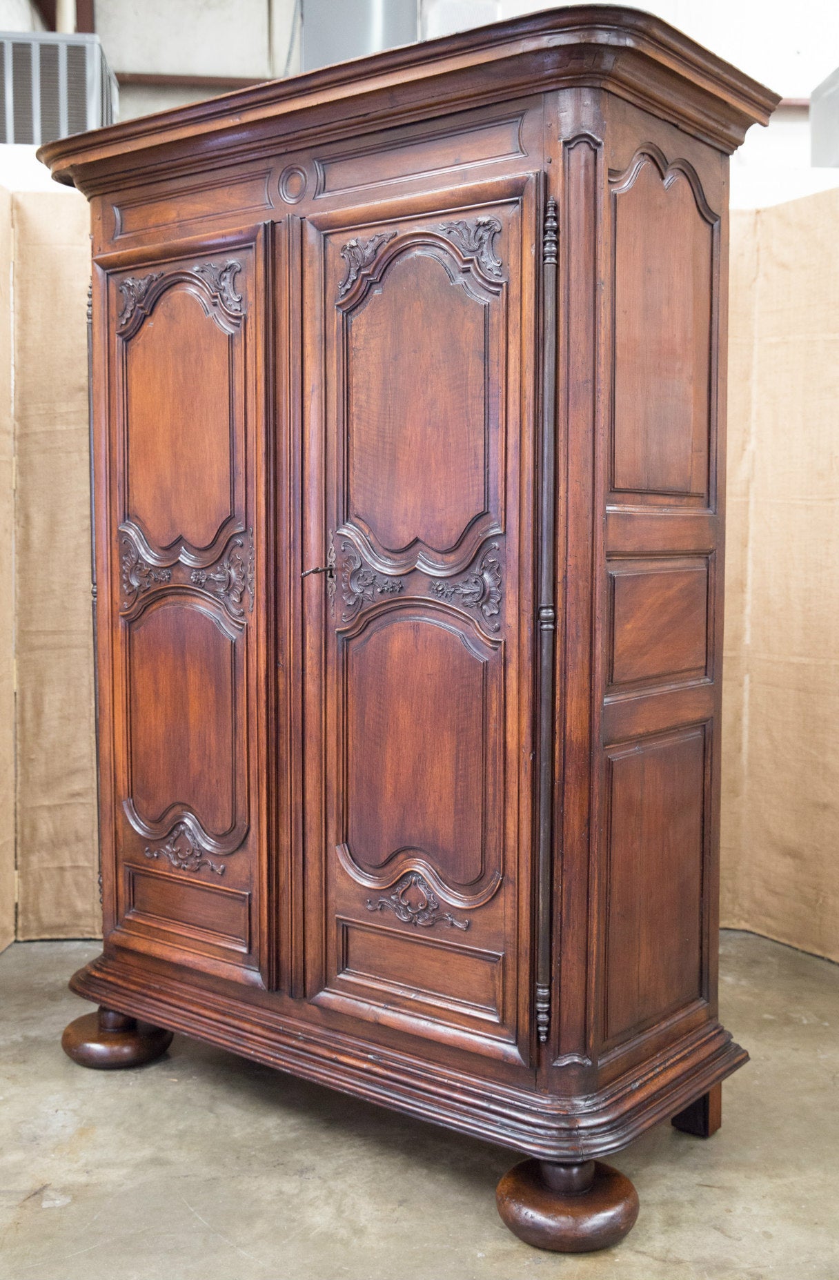 Exceptional late 17th century Louis XIV period armoire handcrafted of solid walnut by skilled artisans near the historic seaside resort of La Baule in the Pays de la Loire region. The stepped cornice sits atop a carved frieze with center galette