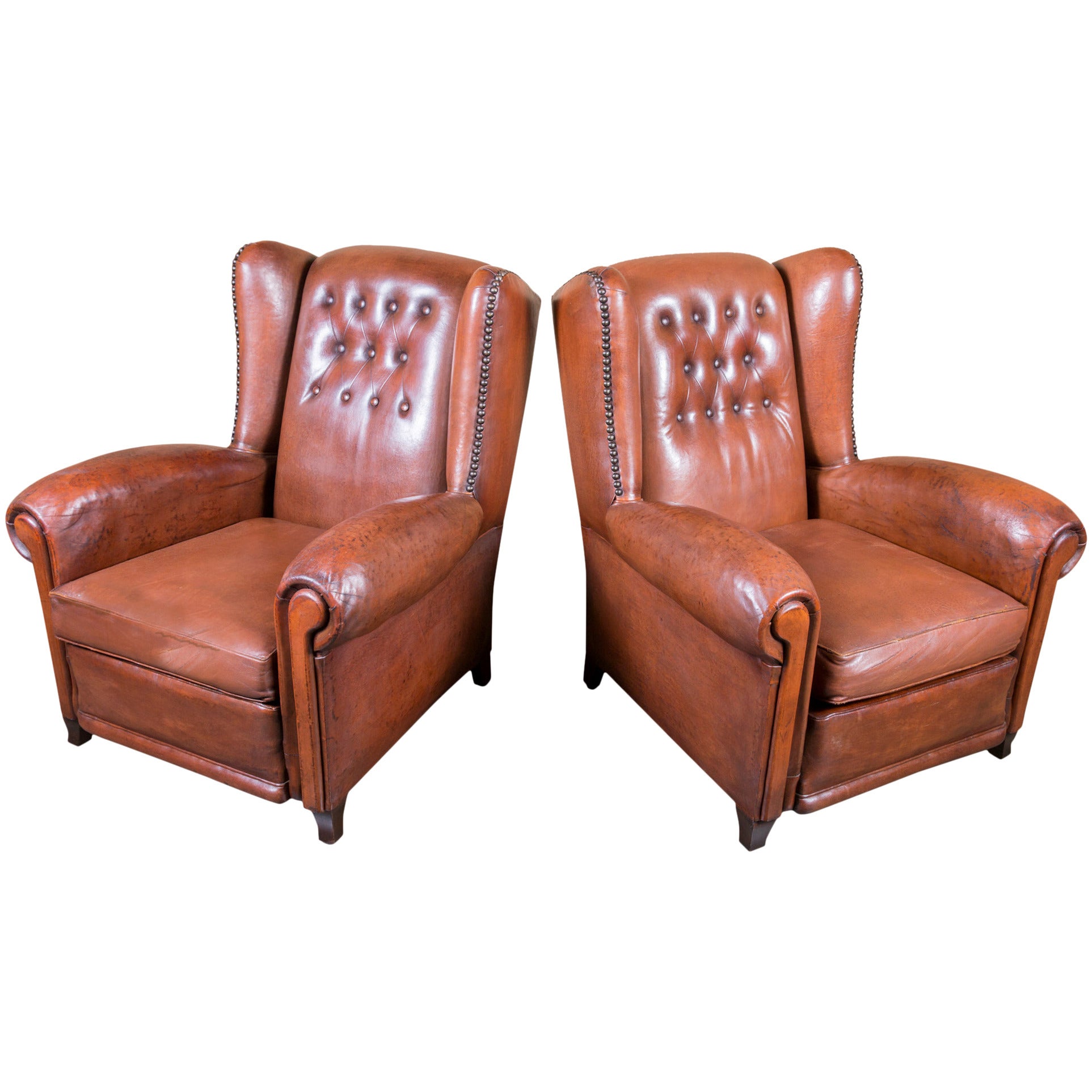 Pair of French Leather Tufted Wing Chairs with Reversible Cushions and Nail Trim